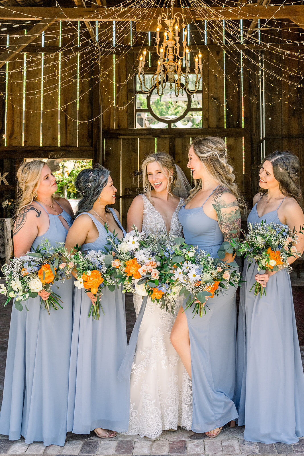 Bride with bridesmaids in dusty blue at Wolfe Heights Estates wedding in Sacramento, CA
