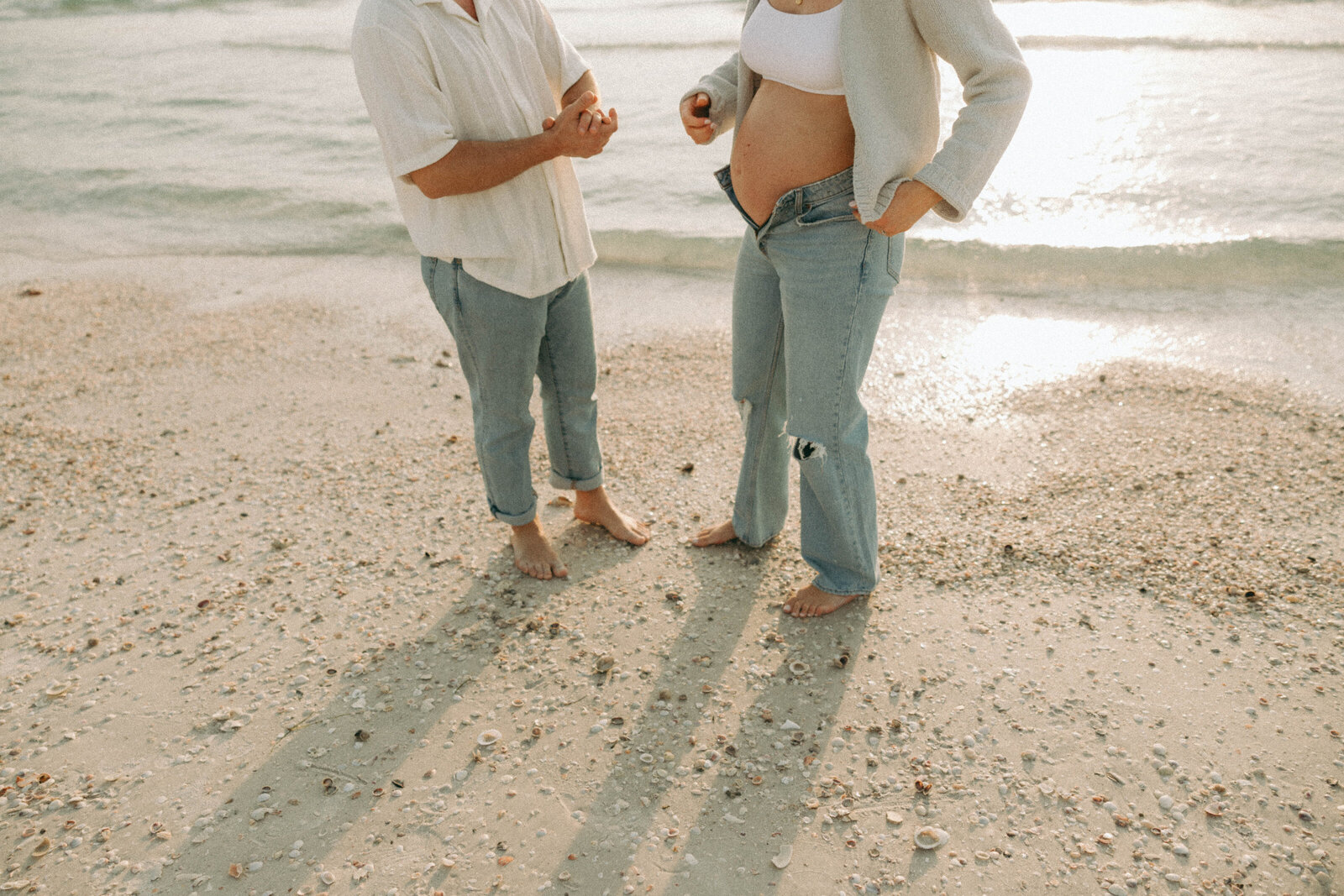 Intimate couple's photo shoot, capturing genuine smiles and love between the couple in a beach setting.