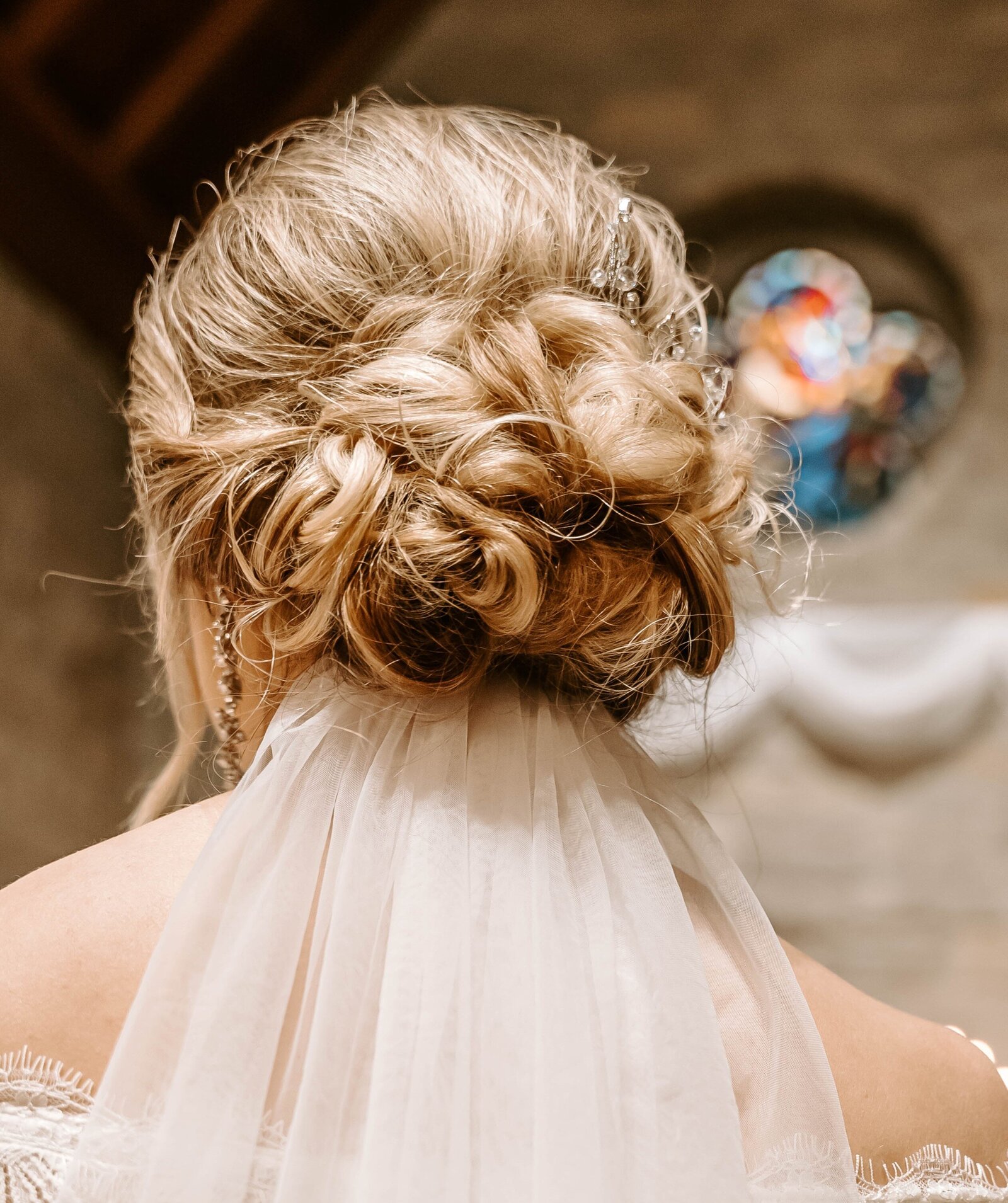 Pilgrims chapel Kansas City Bride's hair low curly textured updo hair stylist Kansas City