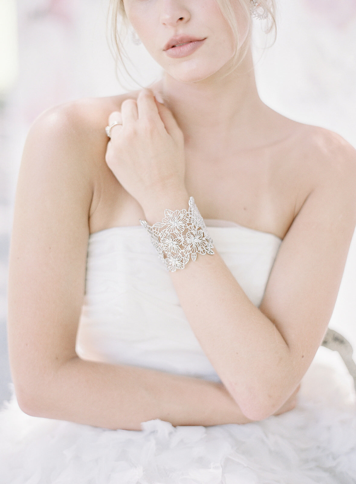 Close up of bride's hand made silver laced cuff on her wrist.  Photographed by wedding photographers in Charleston Amy Mulder Photography