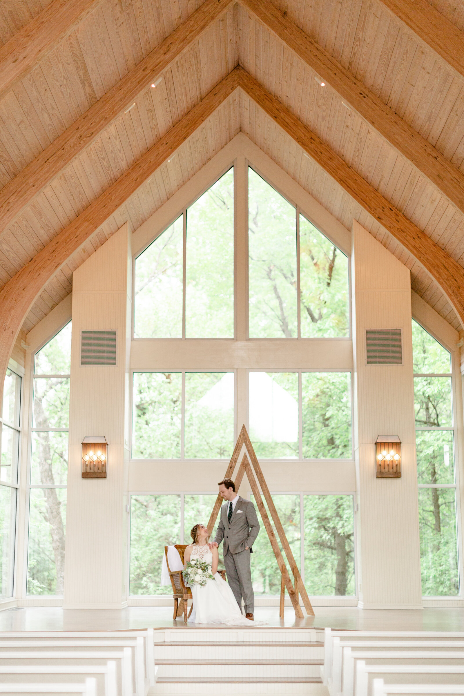 Vaulted ceilings and all glass walls surround this couples wedding ceremony.