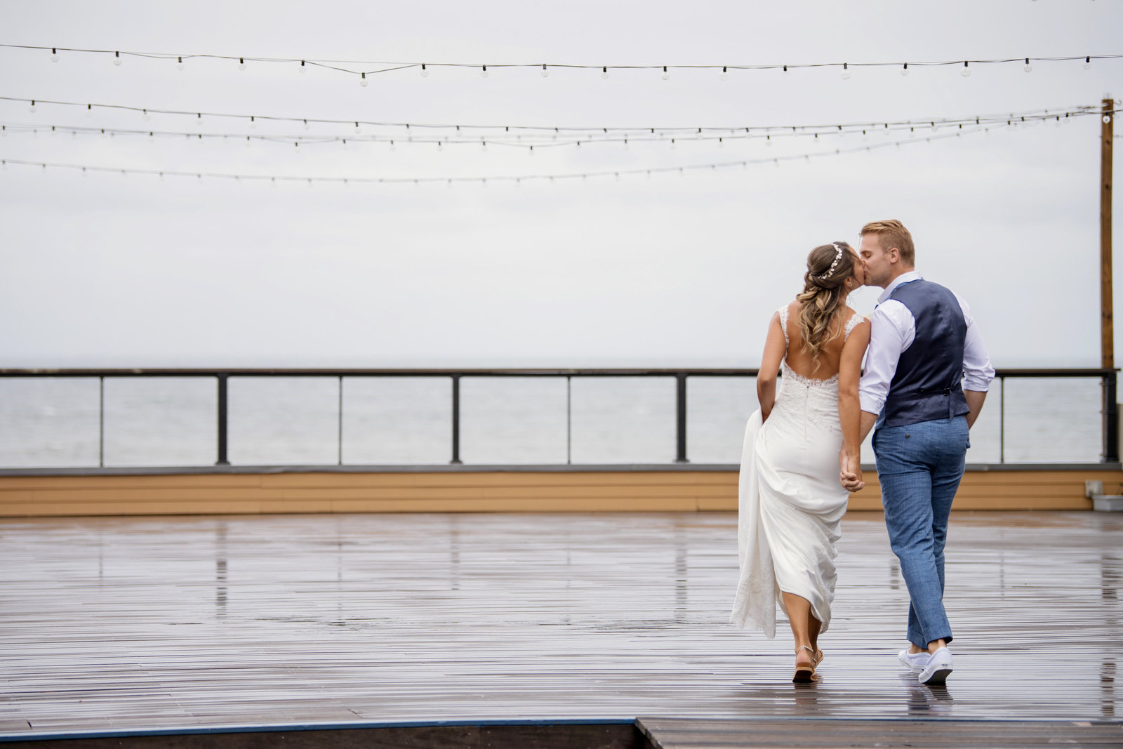 photo of bride and groom from the back kissing Gurneys Montauk Resort wedding