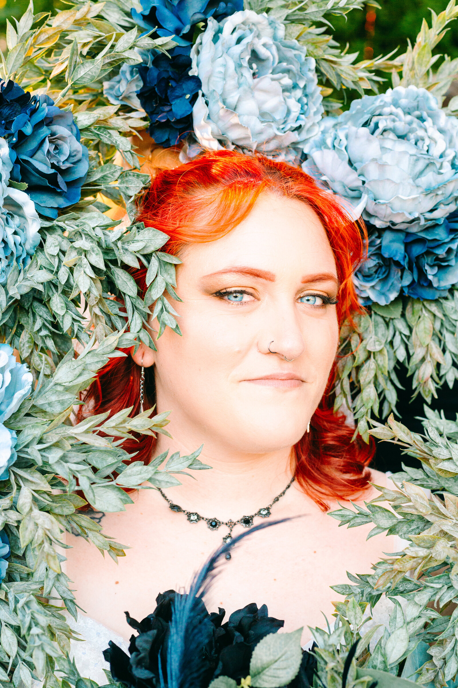 Tattooed bride with colorful wedding flowers.