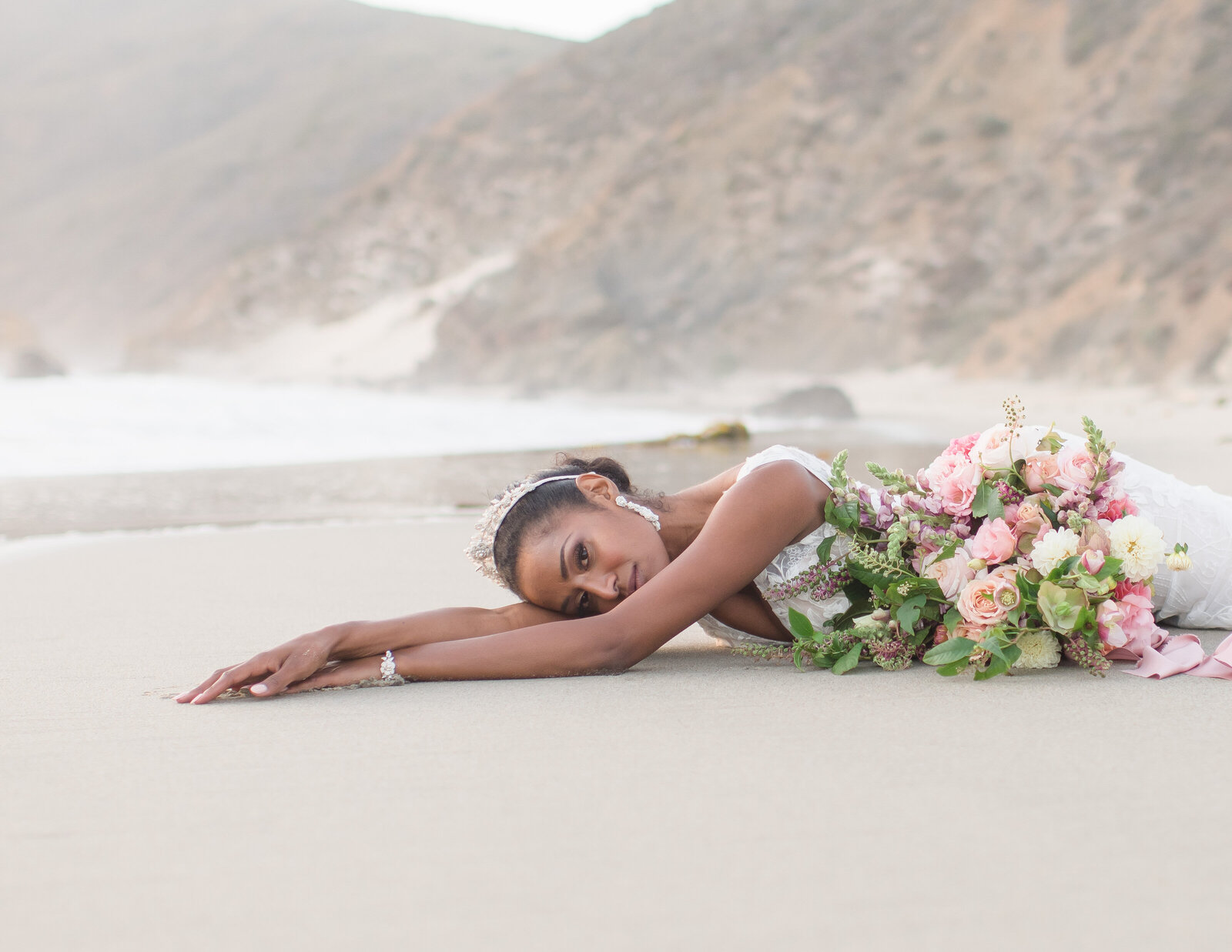 bride laying on beach
