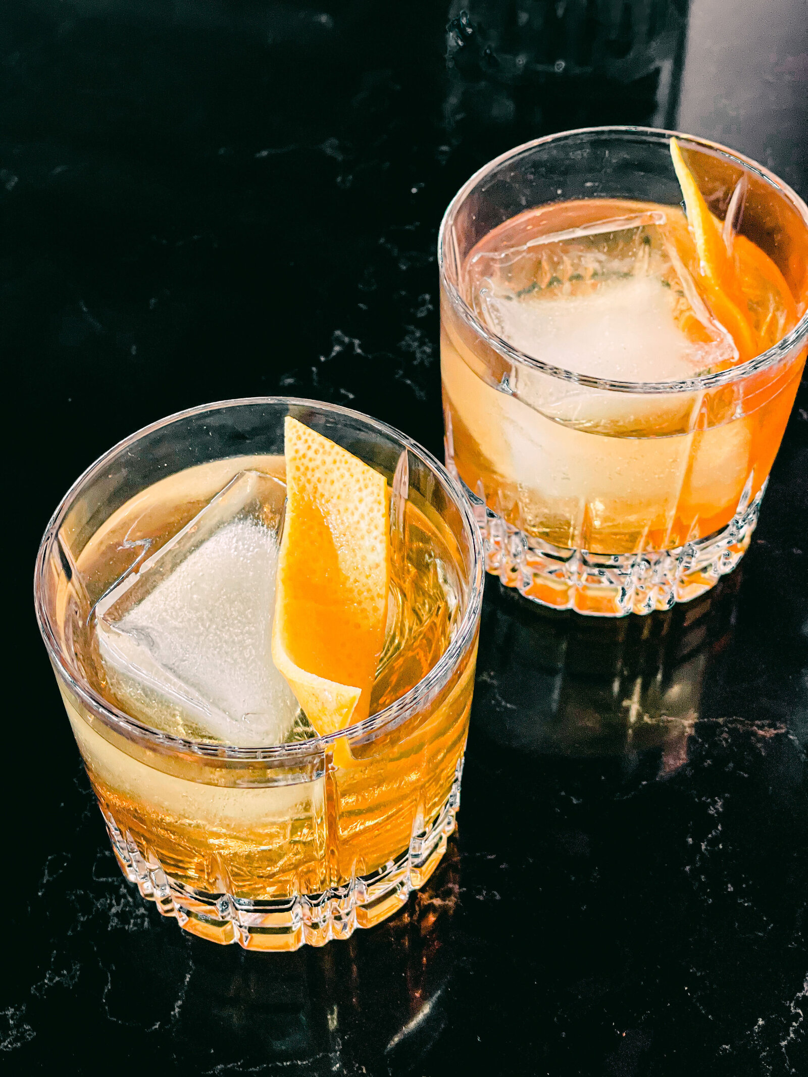 styled cocktail photography on black marble old fashioned whiskey by Chelsea Loren
