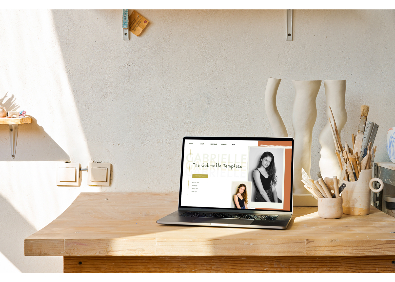 computer sitting on a table with the homepage design on the screen