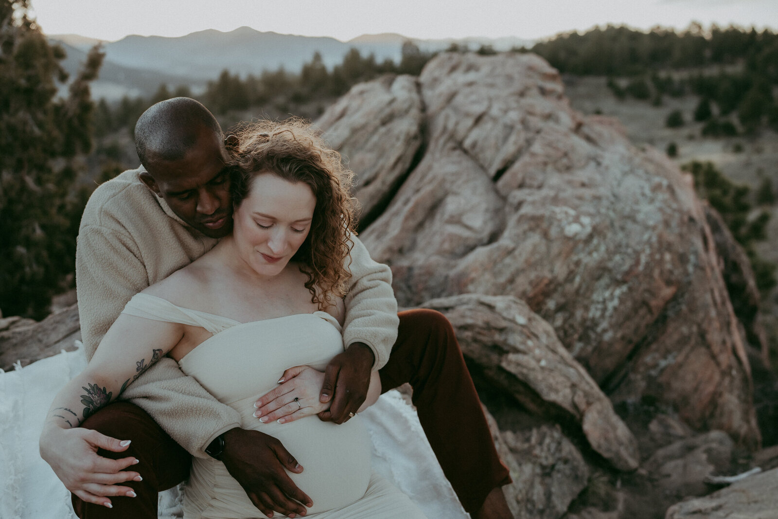 Pregnant couple poses in evergreen Colorado