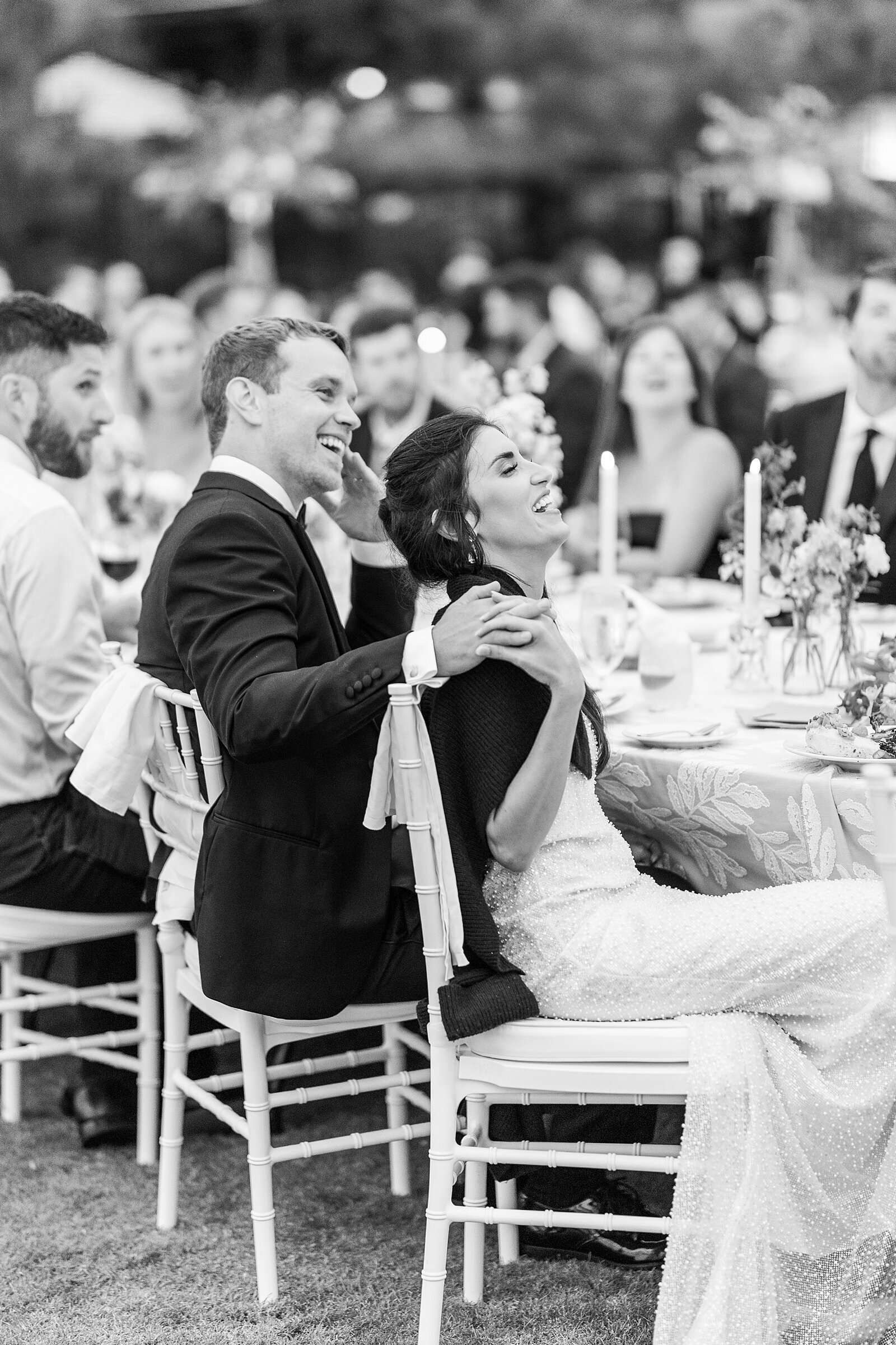 Bride and groom laughing at wedding reception speeches at The Lodge at Torrey Pines.