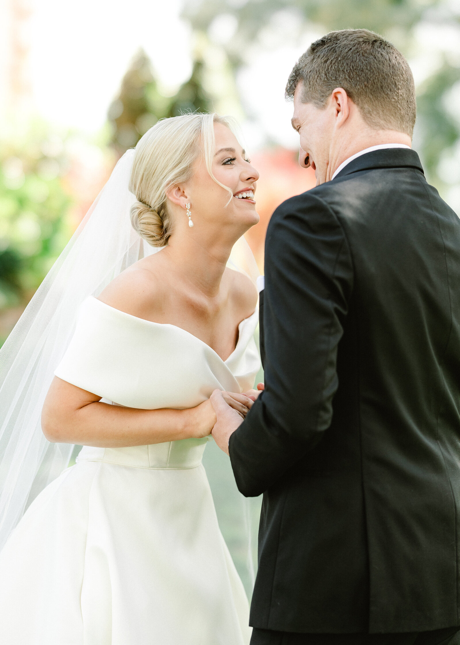 Mallory and Jack sharing a joyful moment during their luxury wedding day captured by an Alabama wedding photographer specializing in fine art wedding photography.