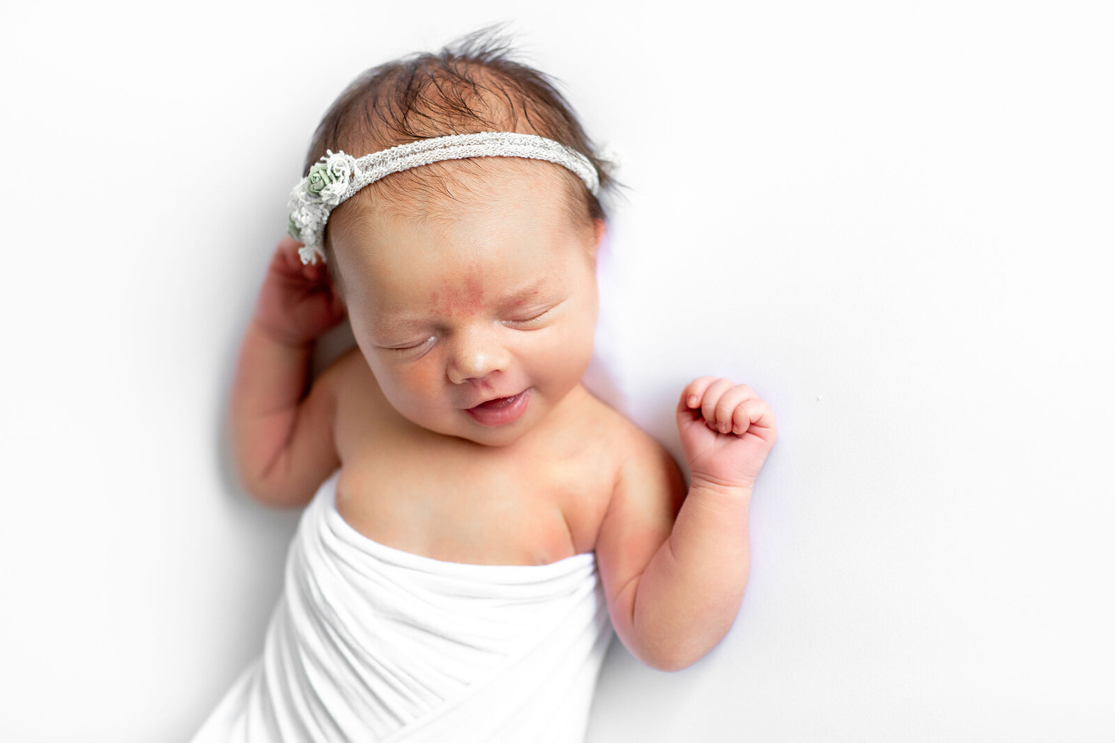 a smiling sleeping baby girl by Bucks County Newborn Photographer Ivory Tree Portraits