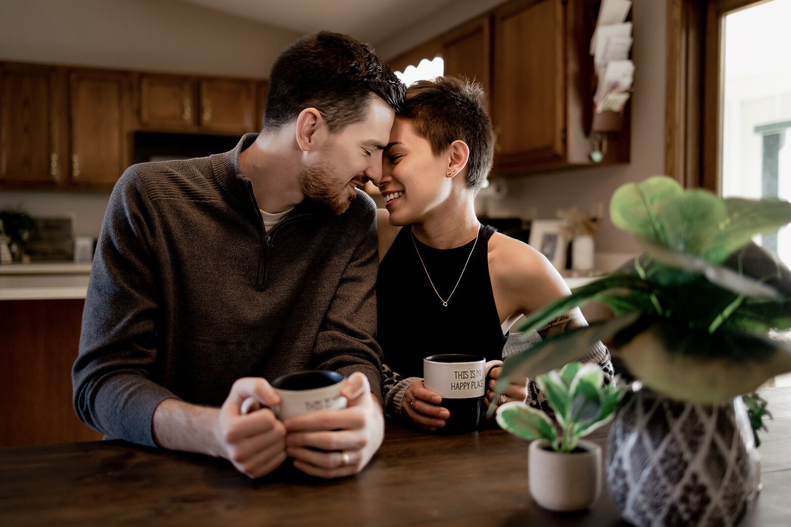 Affectionate couple sharing a cup of coffee in their home