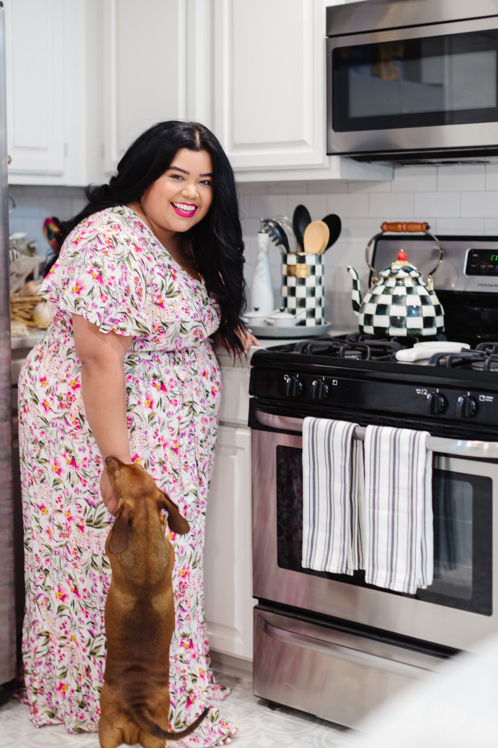 plus size woman in kitchen with dog