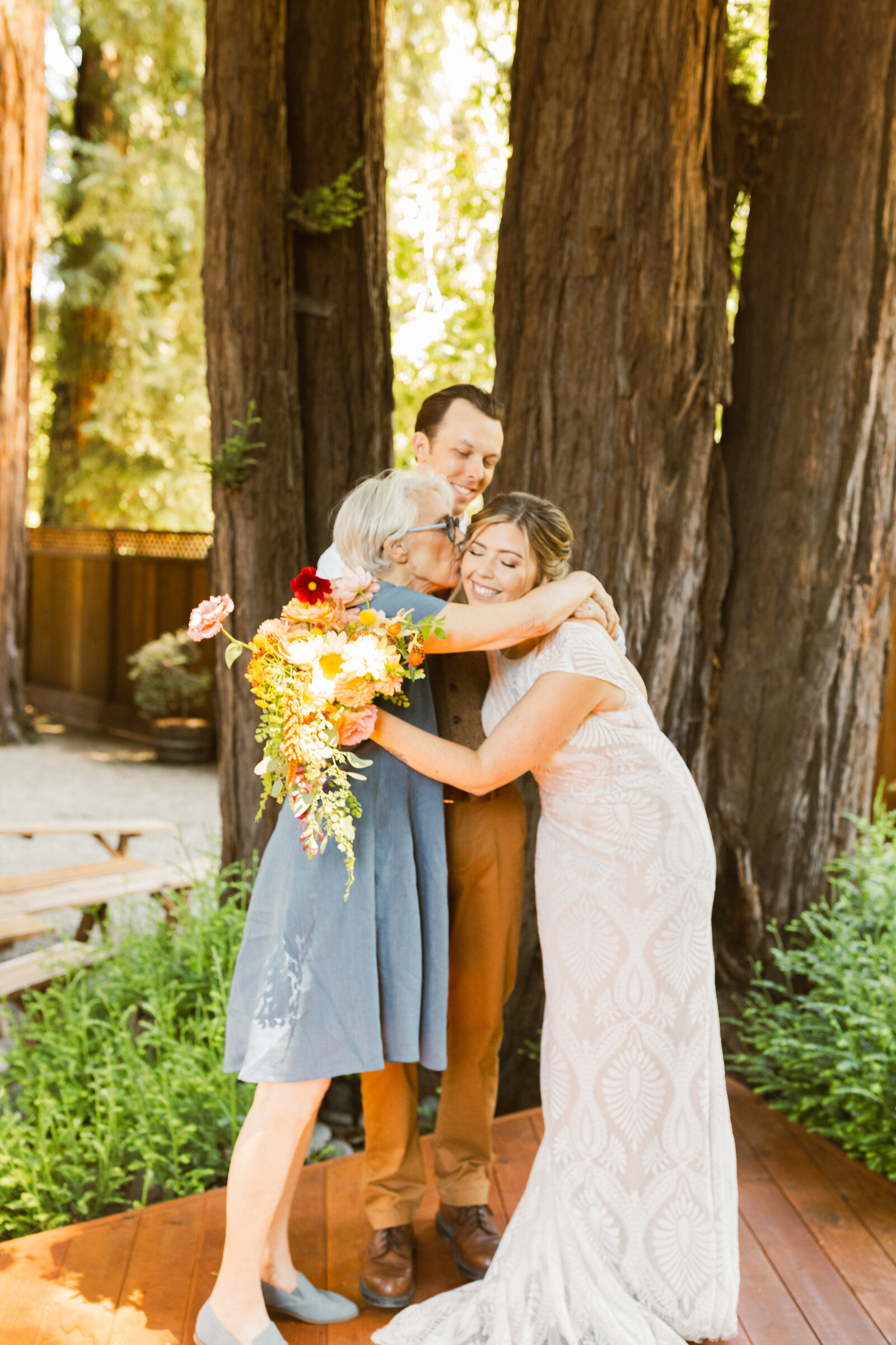 Bridal party at a colorful wedding ceremony in Santa Cruz, California in the redwood trees.