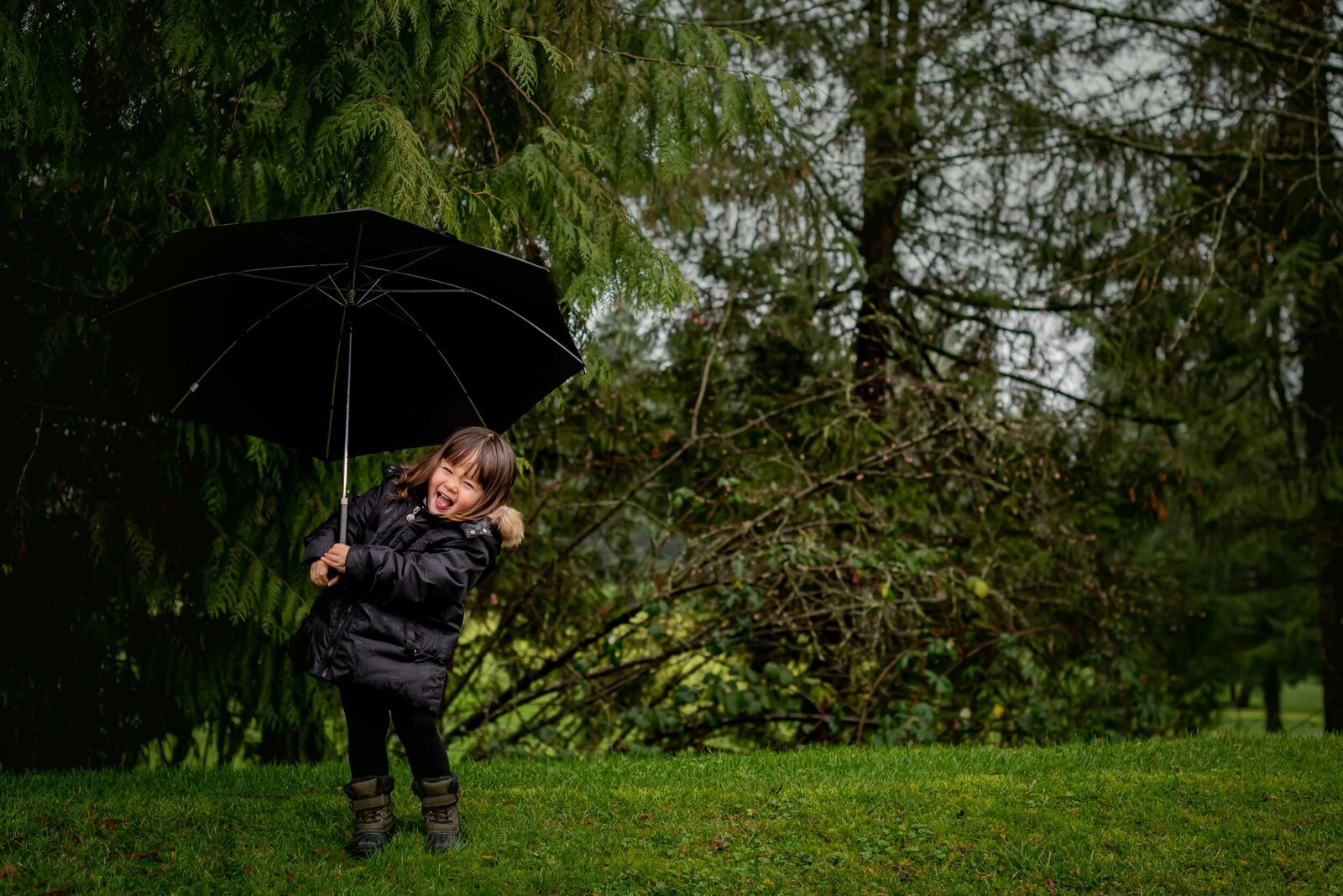 Outdoor family portrait with parents and children, taken in natural Vancouver park setting
