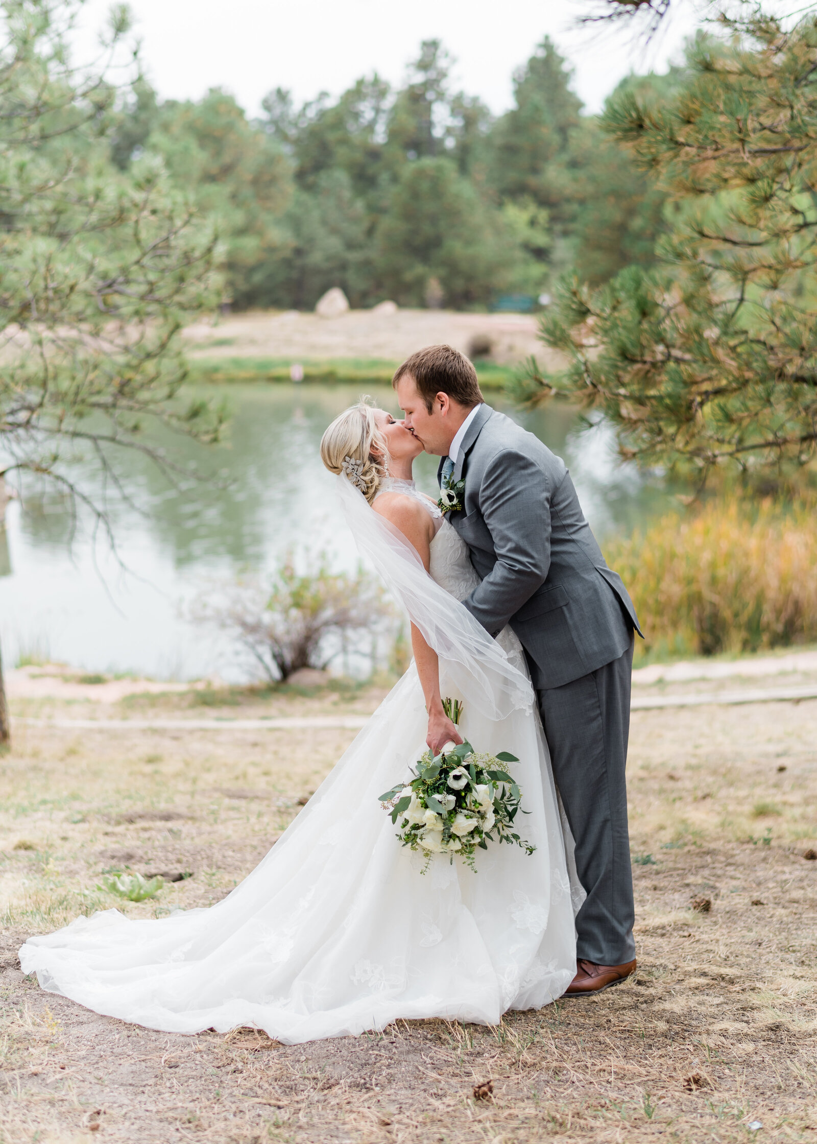 Man and Woman kissing by Denver Wedding Photographer