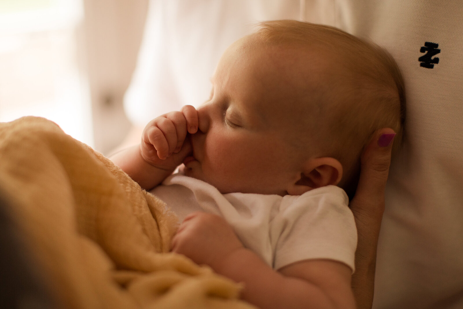 close up of baby sucking thumb