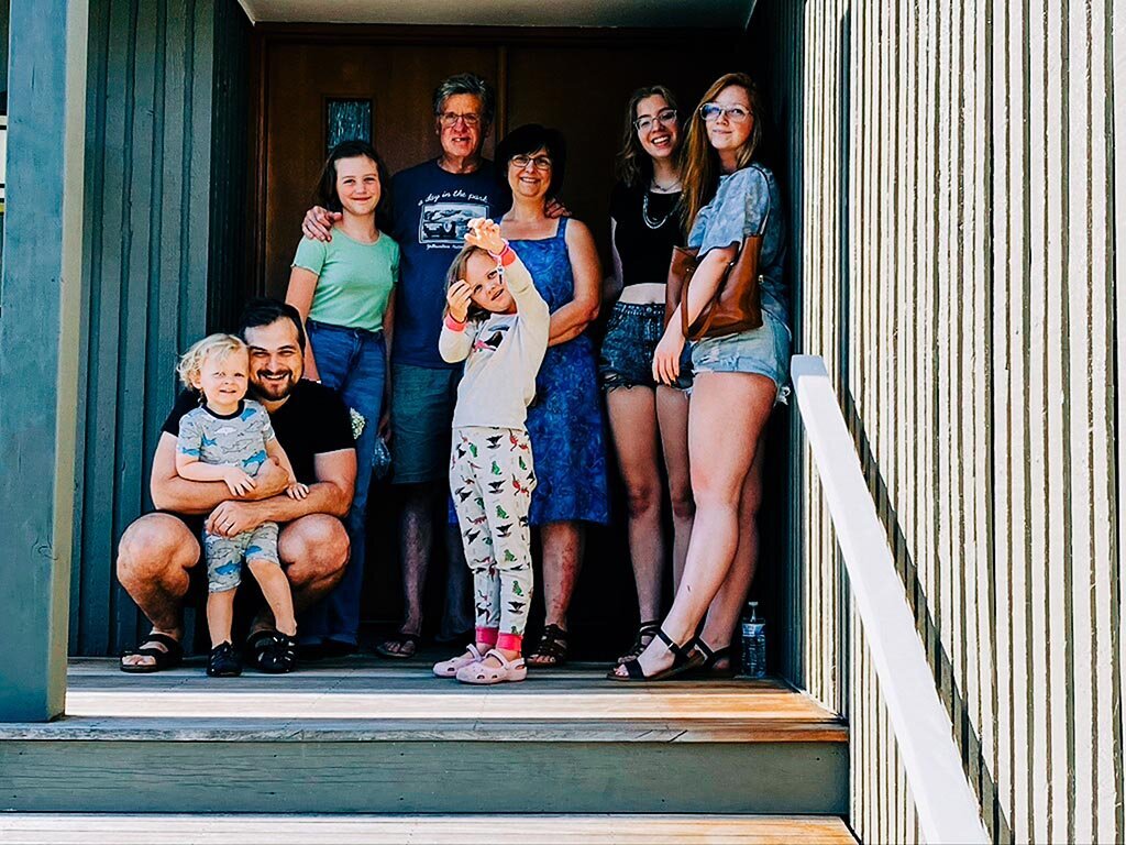A large family on the steps of their new house