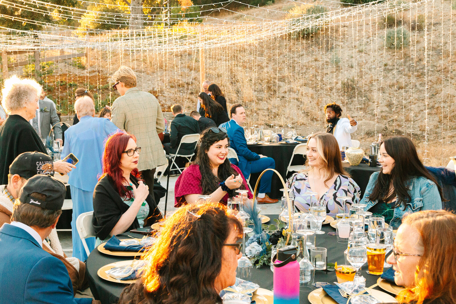 Backyard wedding reception under tea lights.
