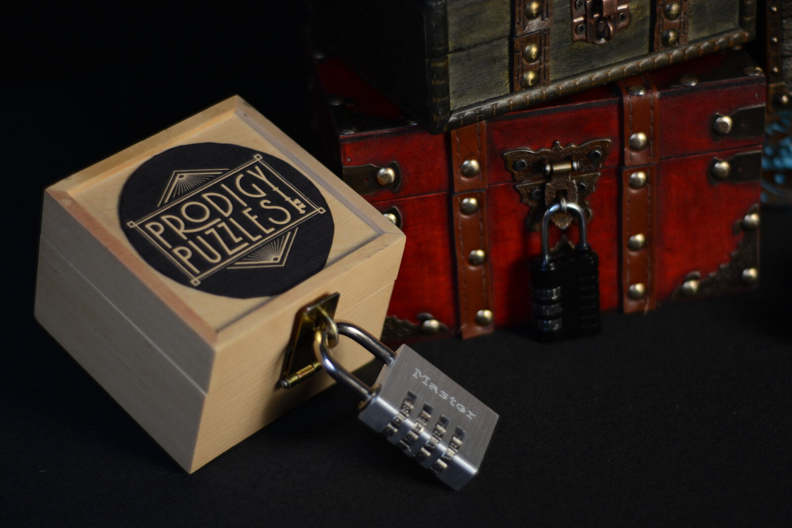 wooden box with lock and the Prodigy Puzzles logo