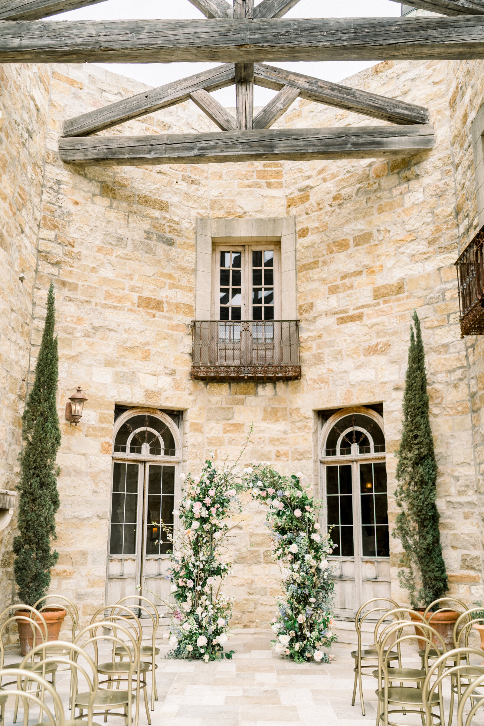 Floral wedding ceremony alter arch at Sunstone Winery in Santa Ynez, CA