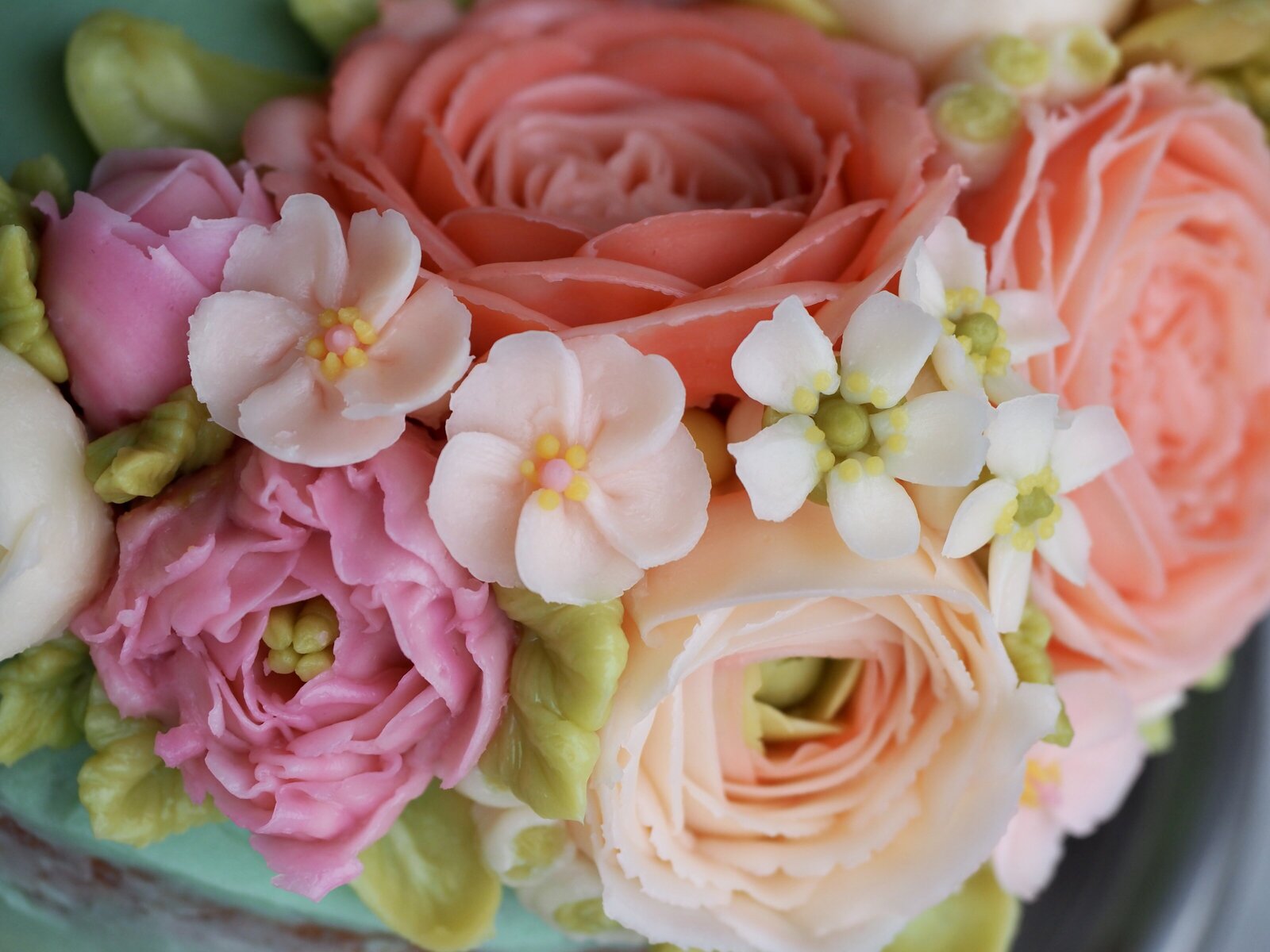 Close up of detailed flowers on a buttercream cake