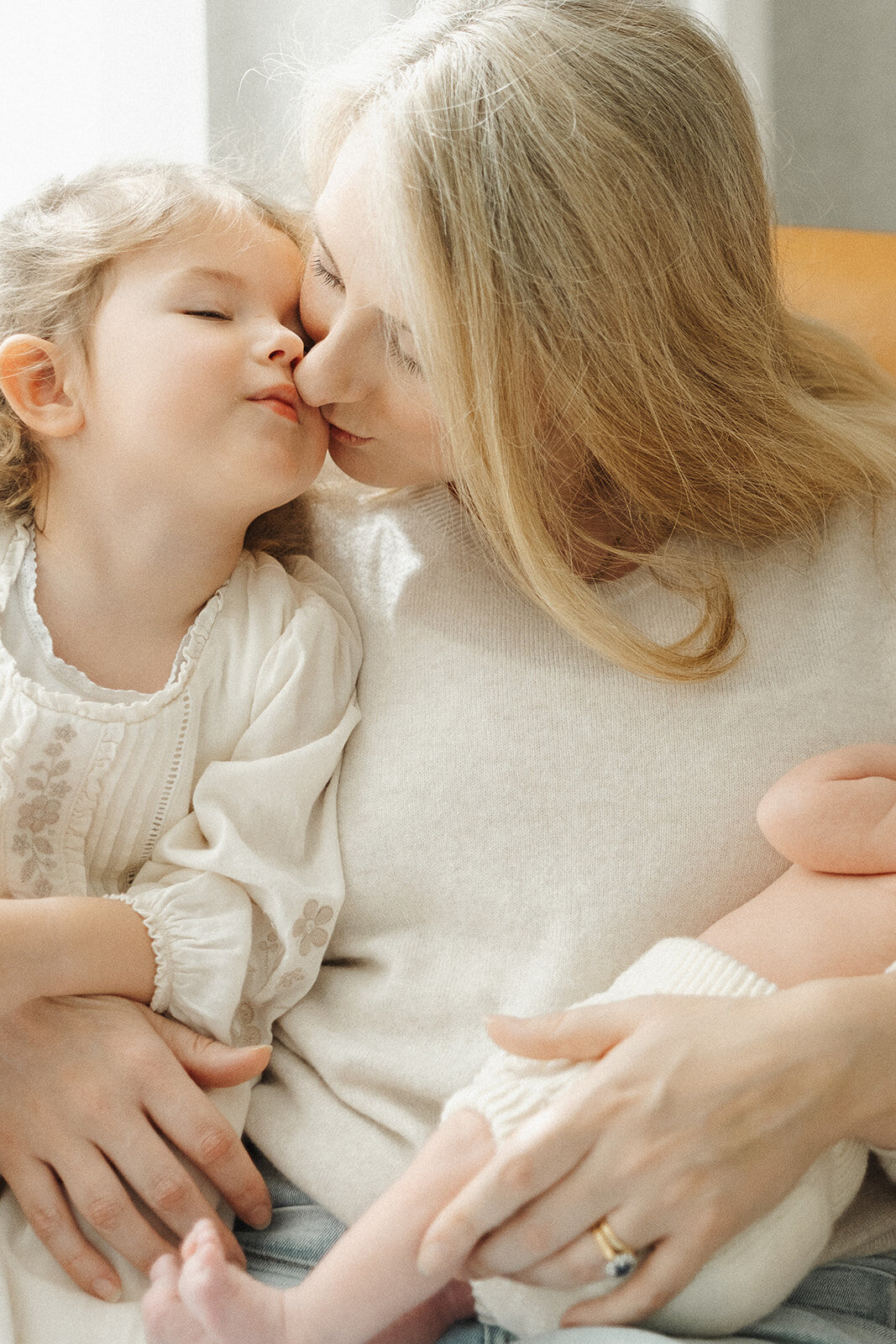 unposed in-home newborn photographer Melbourne toddler kissing mum