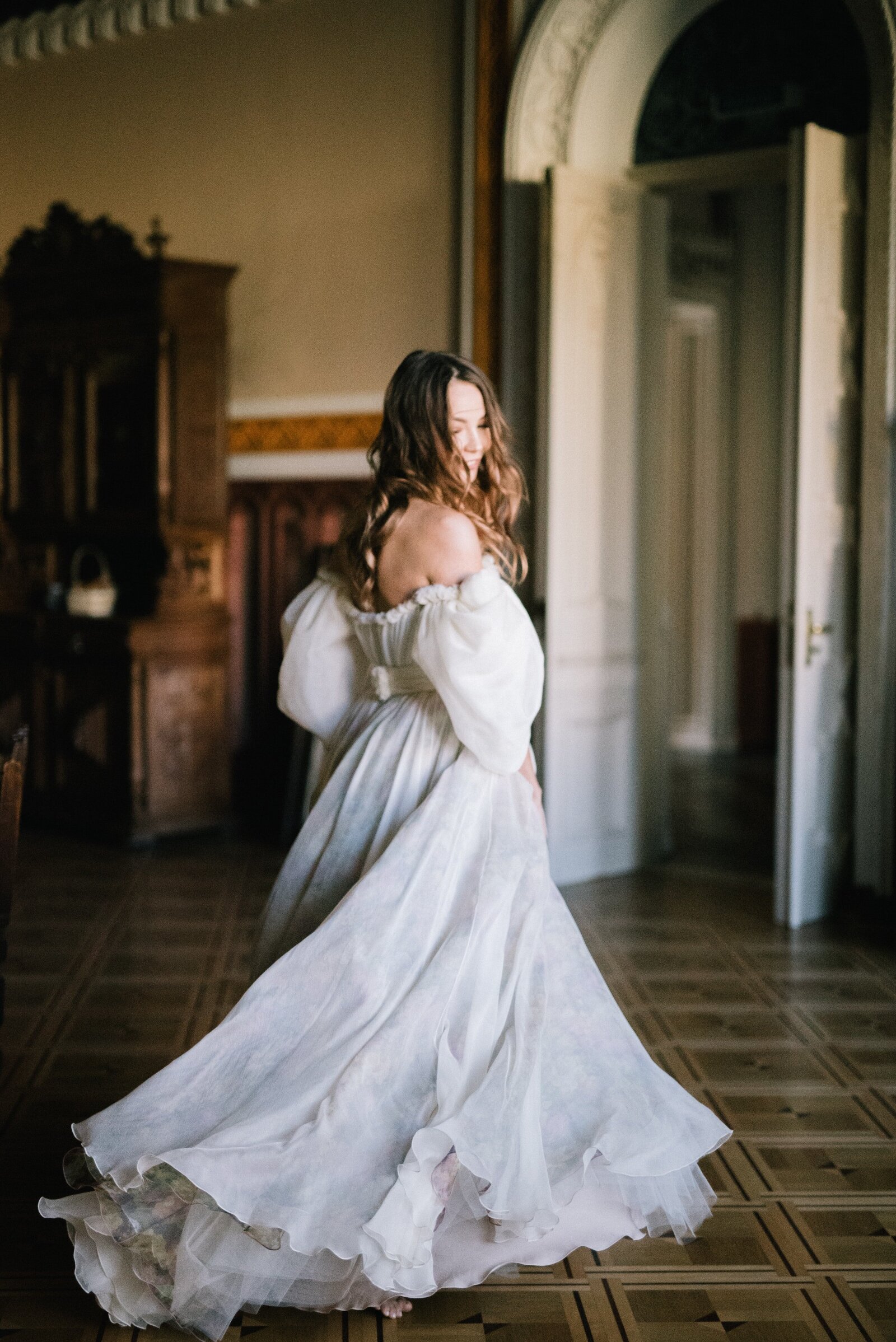 bride wearing flowy white wedding dress with long sleeves