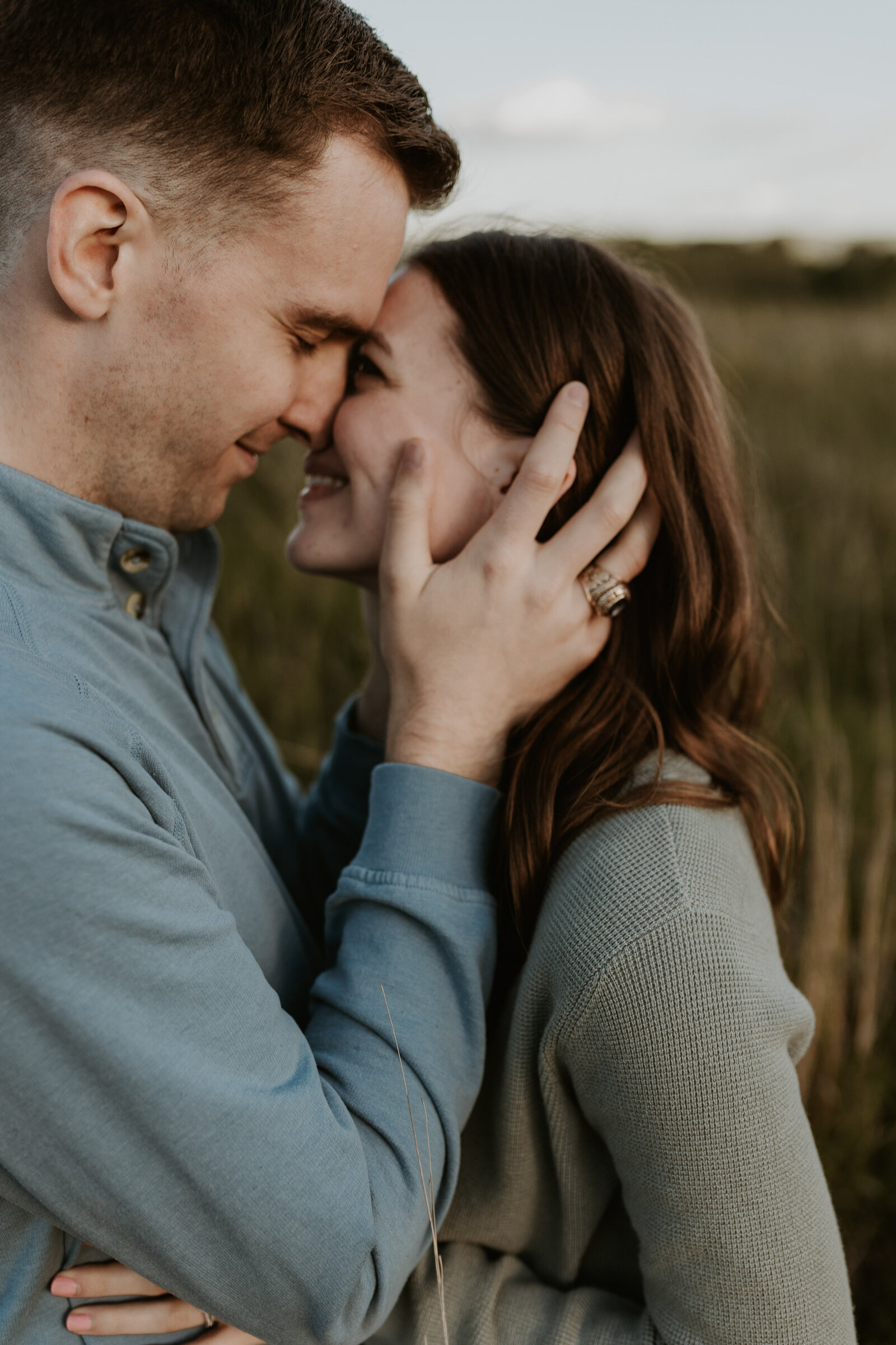 A man holds a woman's face in his hands closely