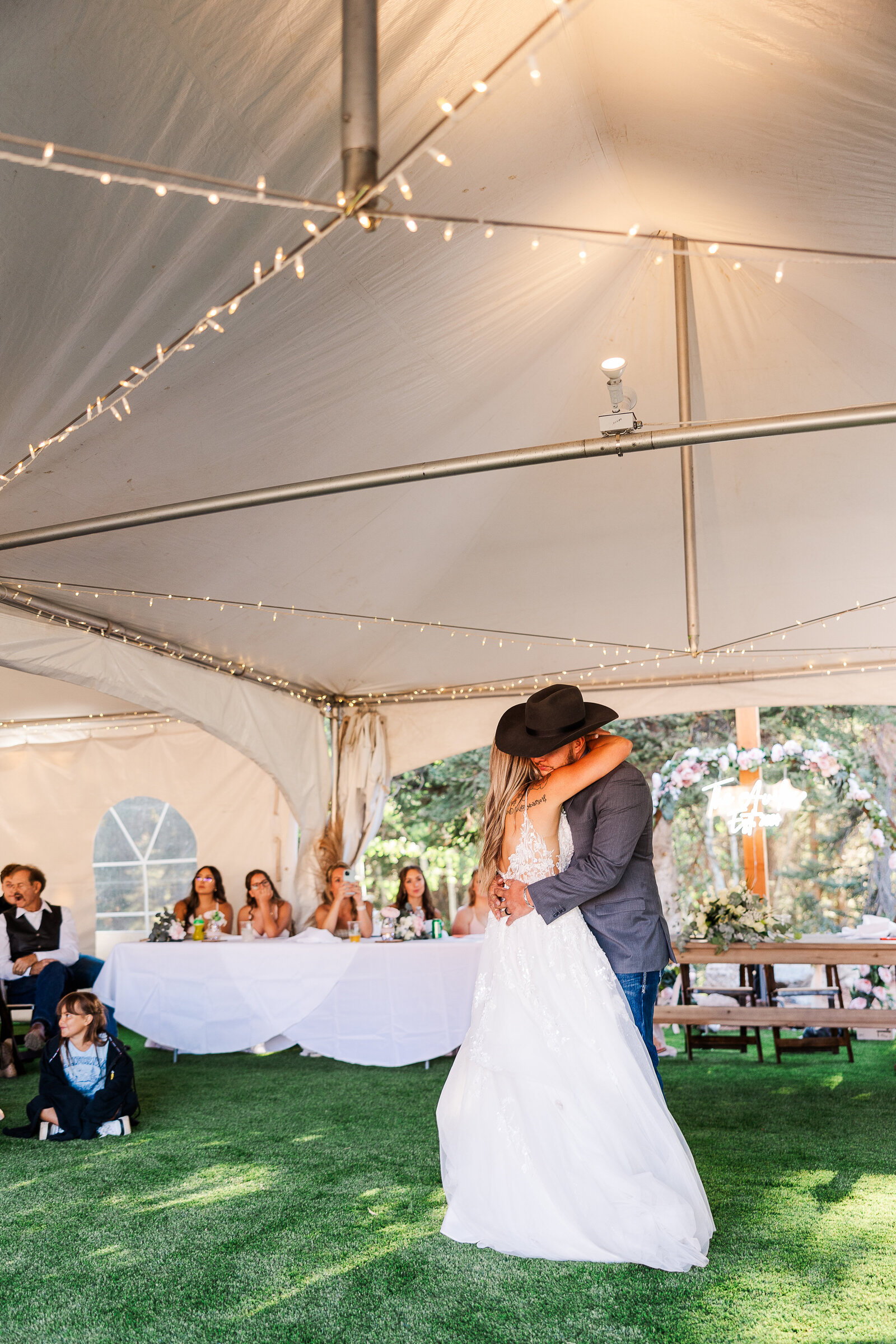 Bride and groom share a sweet embrace as they hug after their first dance in arrowhead Co