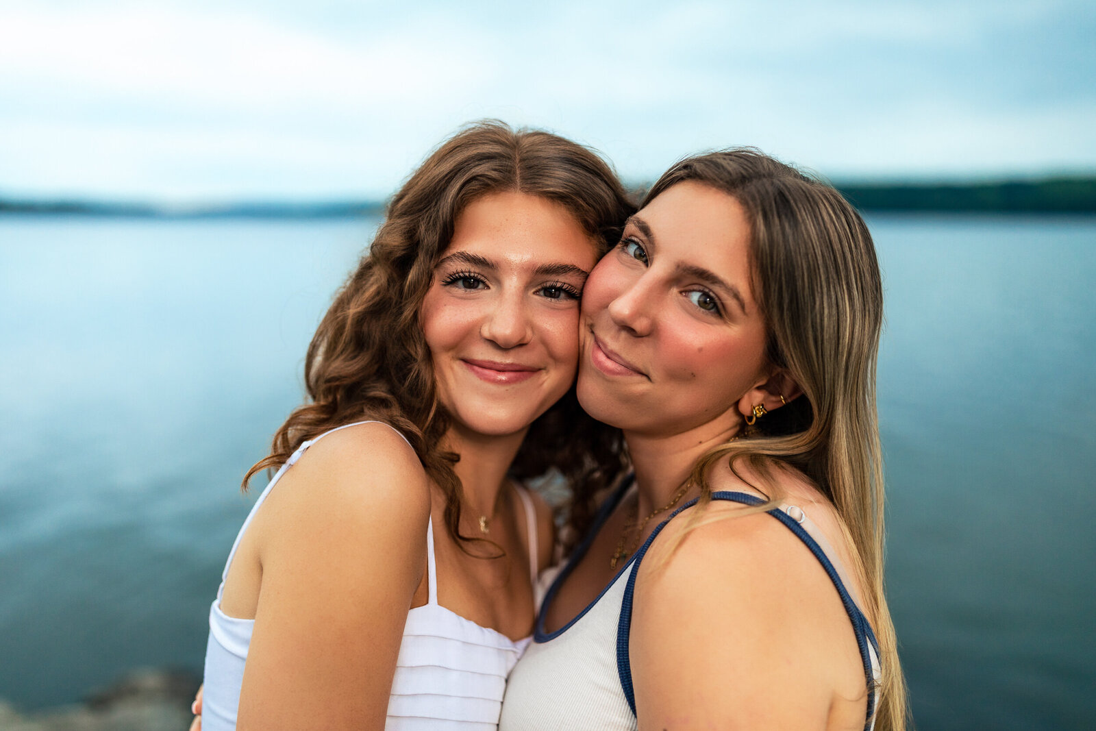 Two senior students Pose with soft smiles at the lake