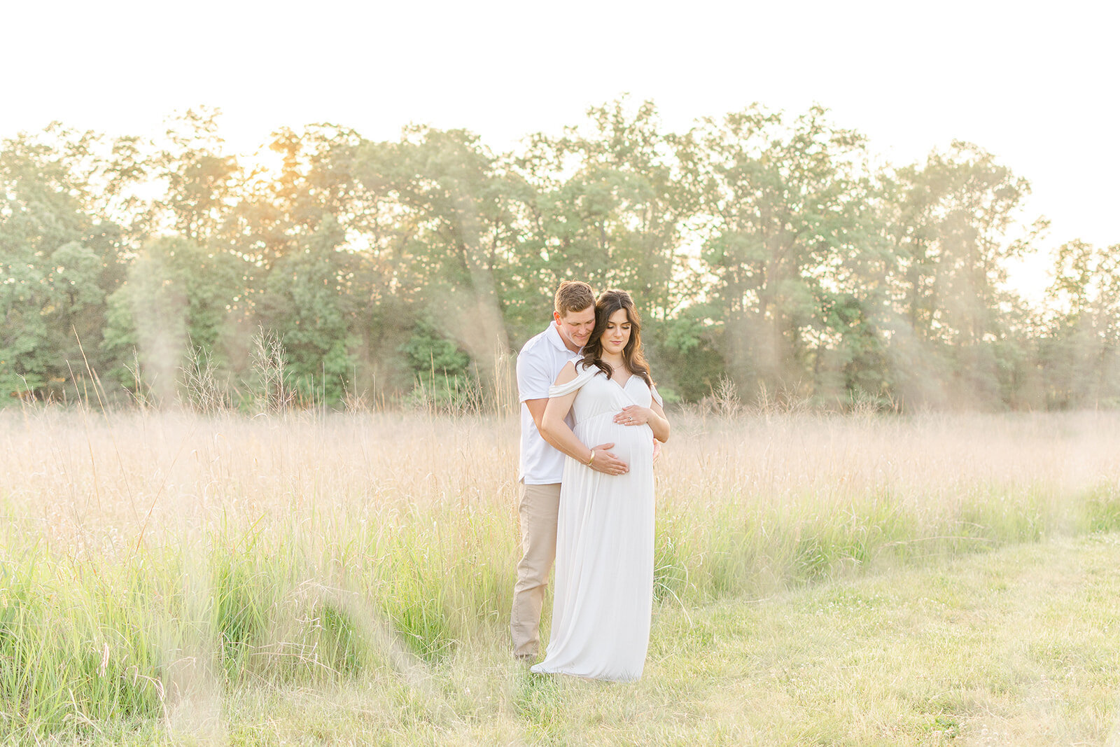 expecting couple in the middle of a field in Catlett, VA