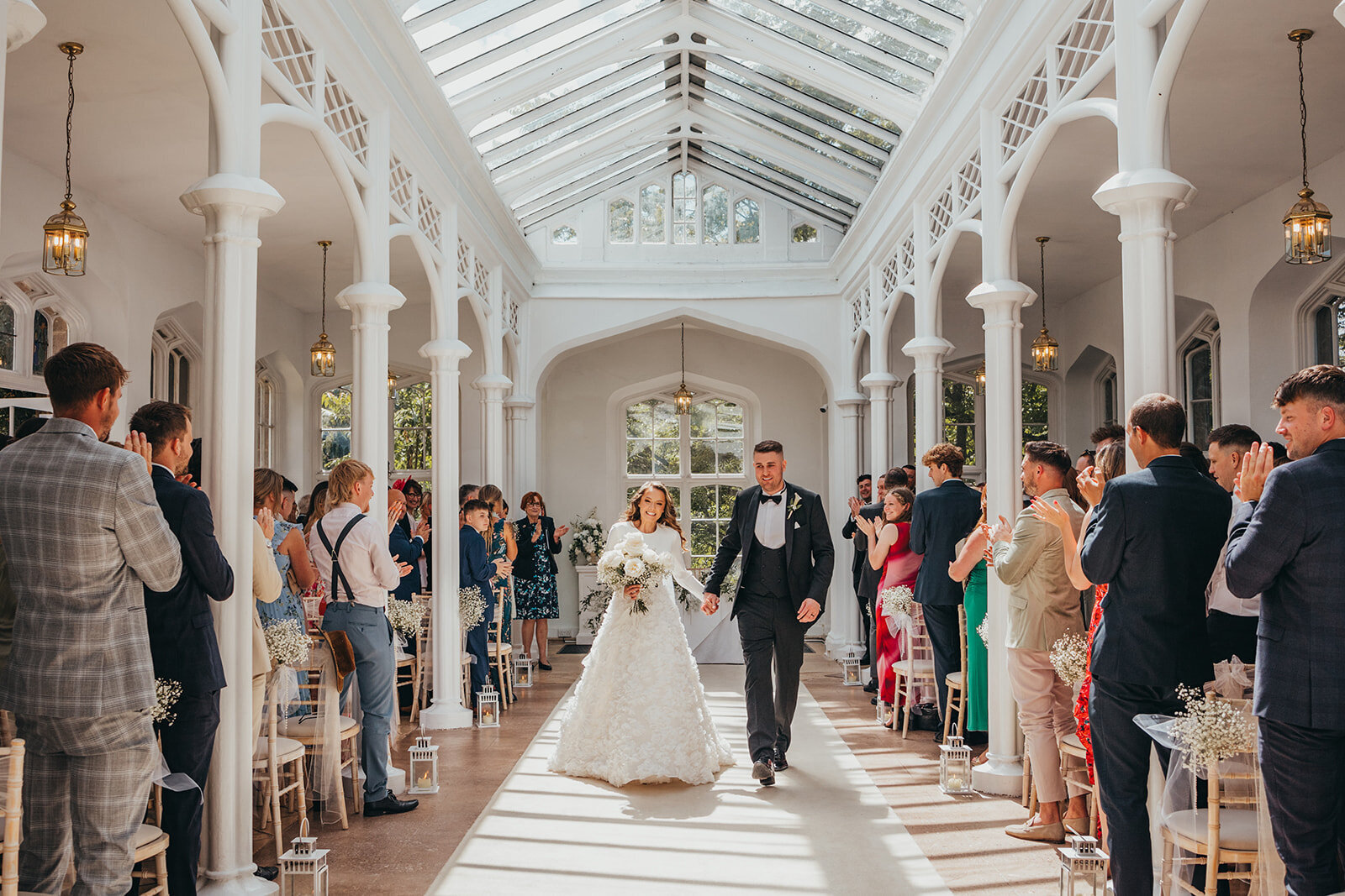 bride and groom applauded by guests