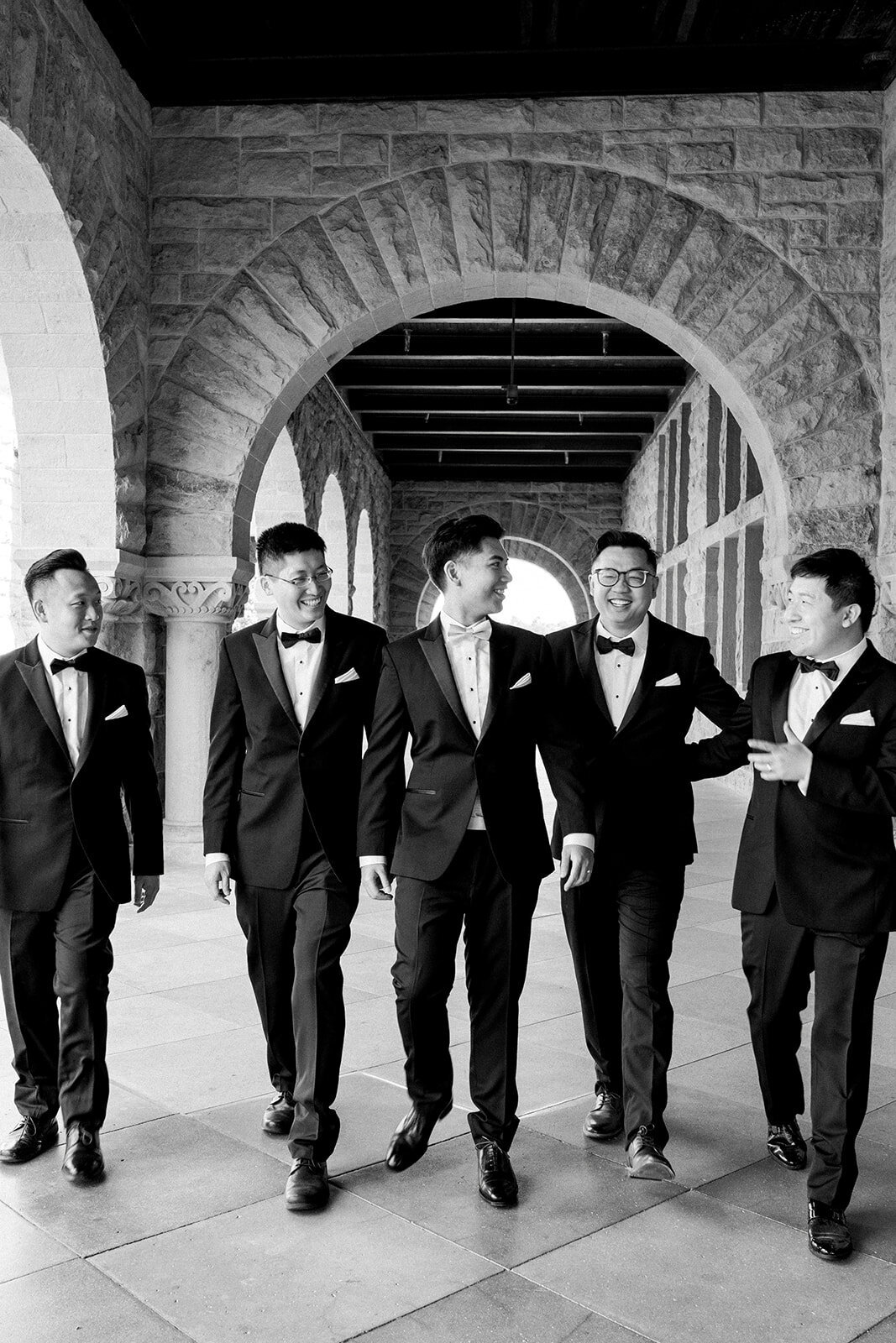 The groomsmen celebrate the wedding day at Stanford University, adding a fun and joyful moment to the elegant ceremony.