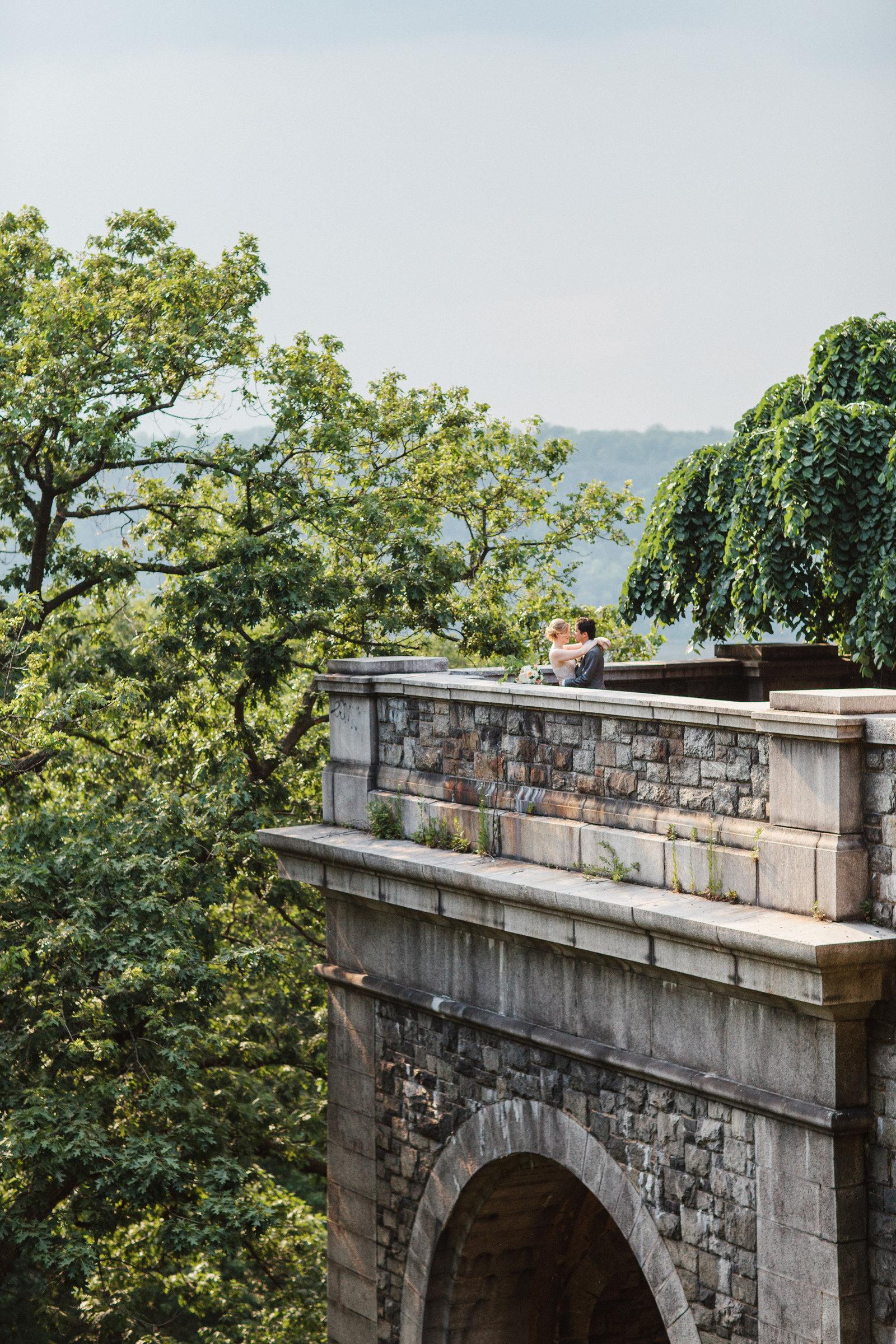 Bride and groom photographed on a historic man made building in Pennsylvania.