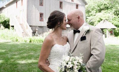 Bride and Groom in front of the Country Strong barn.