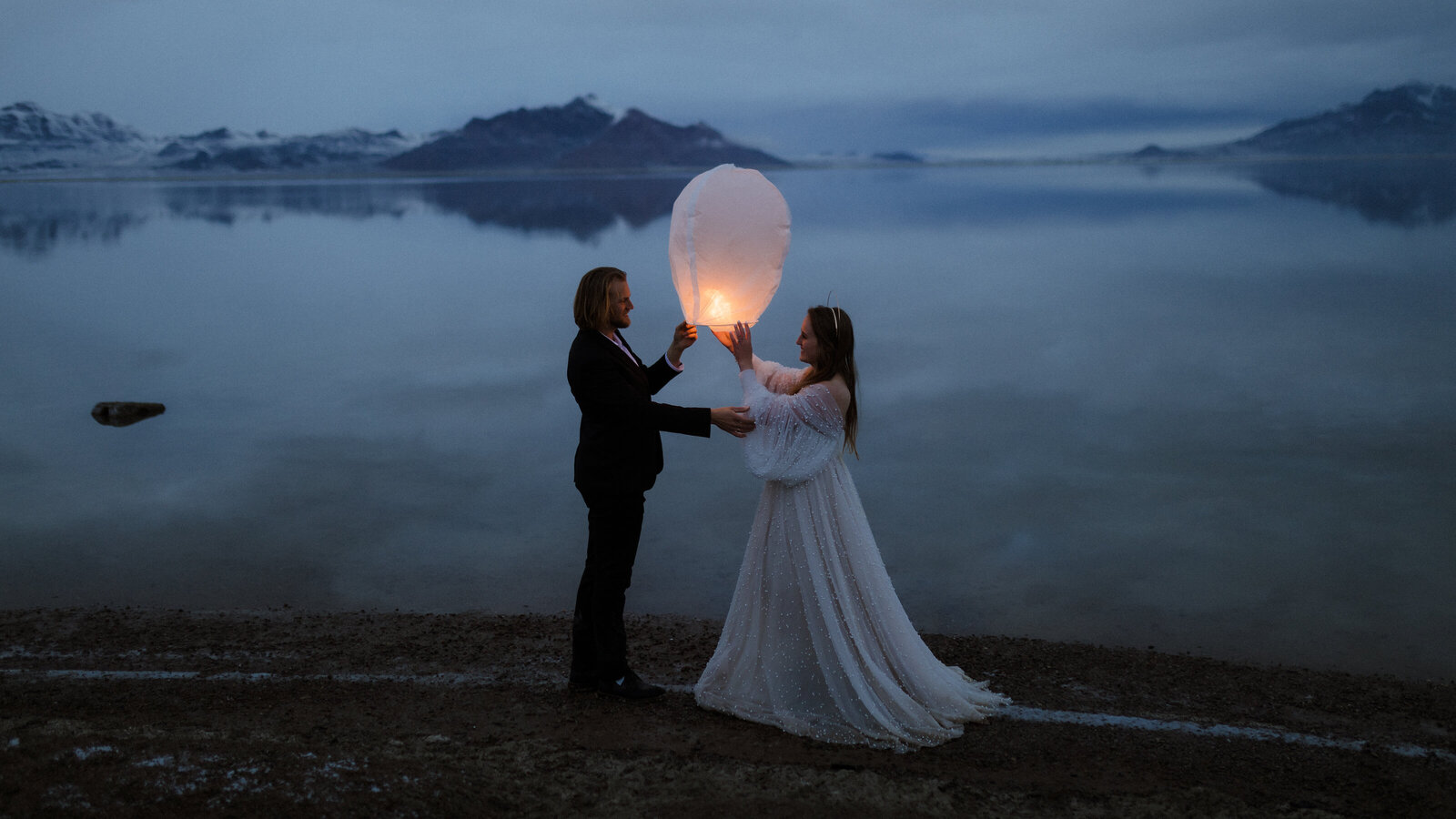 Bride and groom holding a lantern