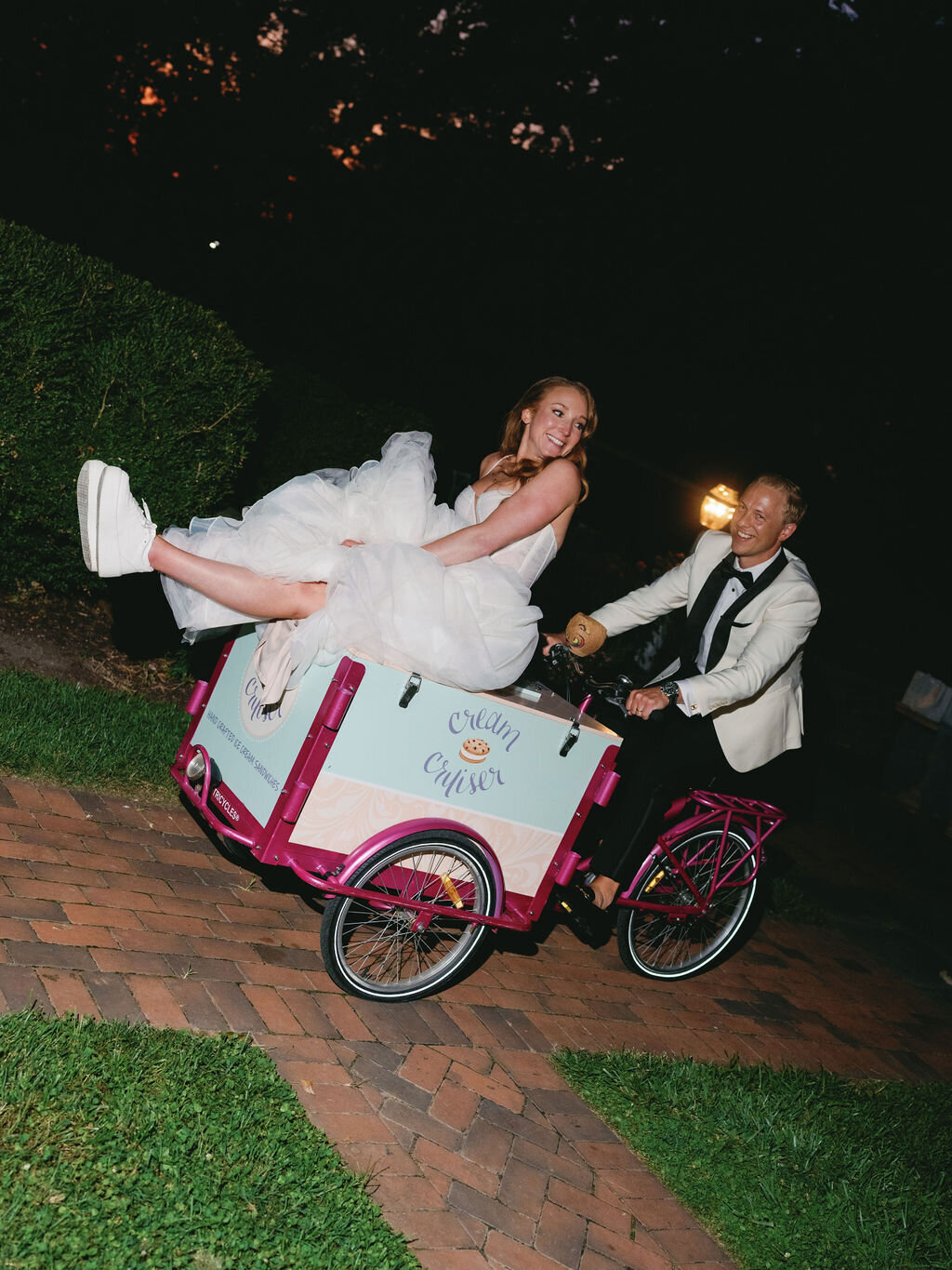 Groom pushing bride on an ice cream bike.