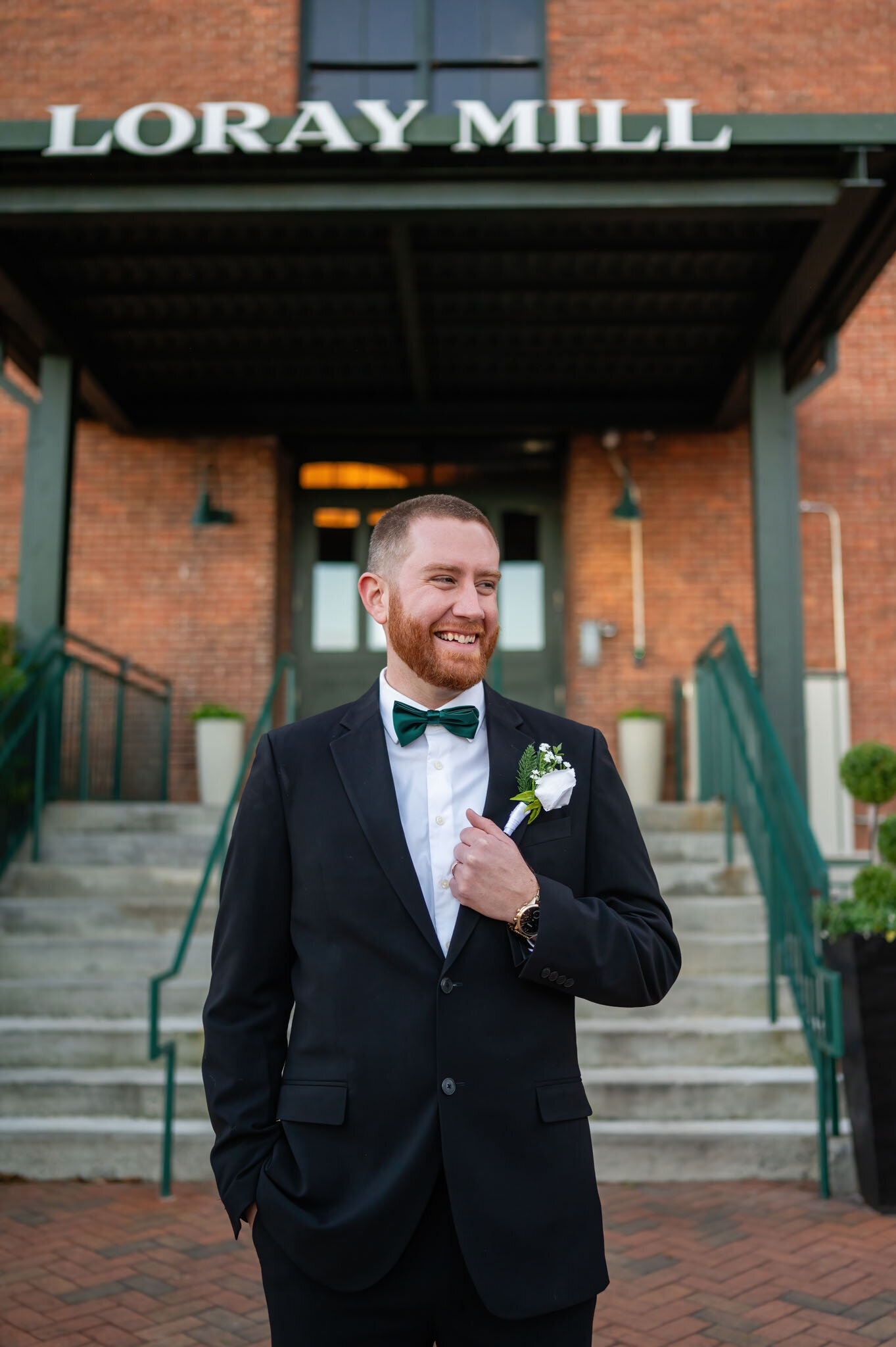 Groom smiling wearing his coat