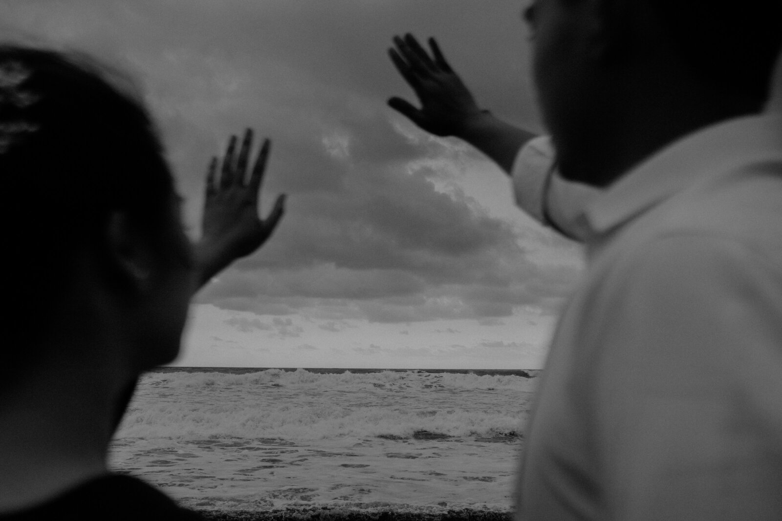 couple raised their hand and look at sky