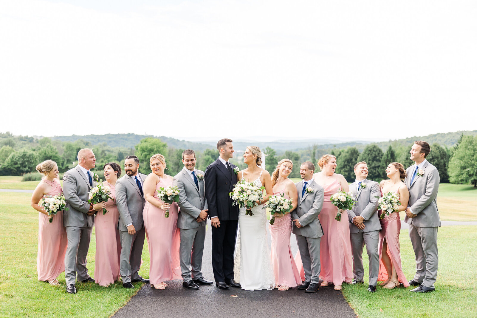 Full wedding party posed for a formal portrait at SkyView Golf Club in Sparta, NJ