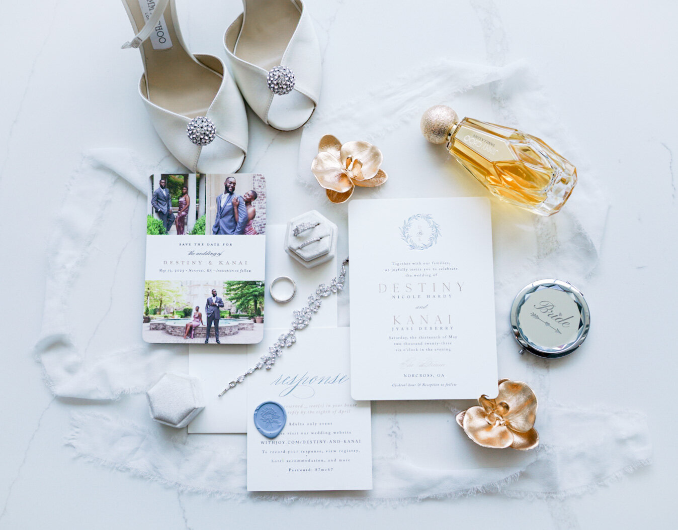 Wedding day details displaying the brides shoes, jewlery and invitation suite.