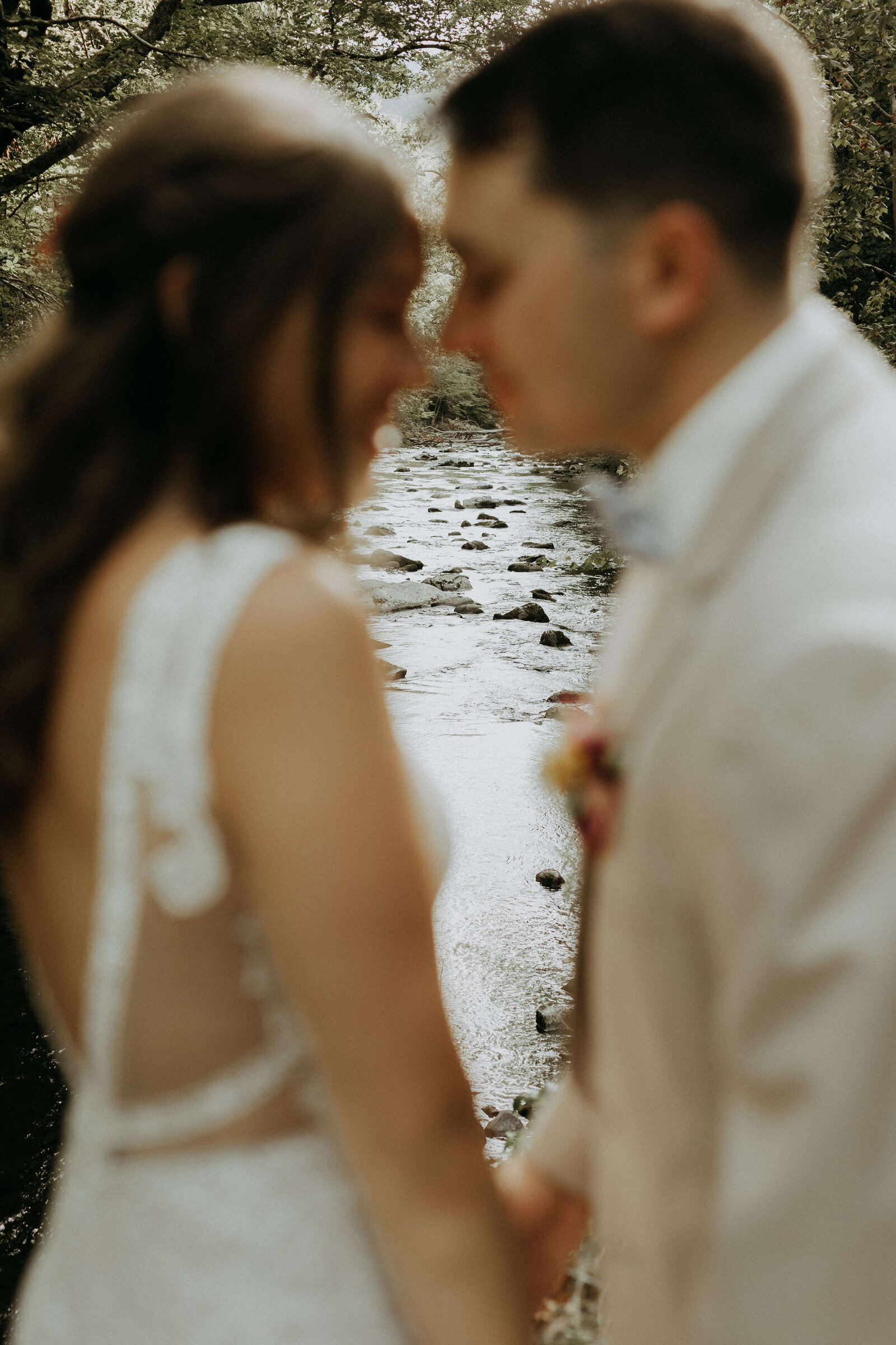 bride and groom portraits by creek