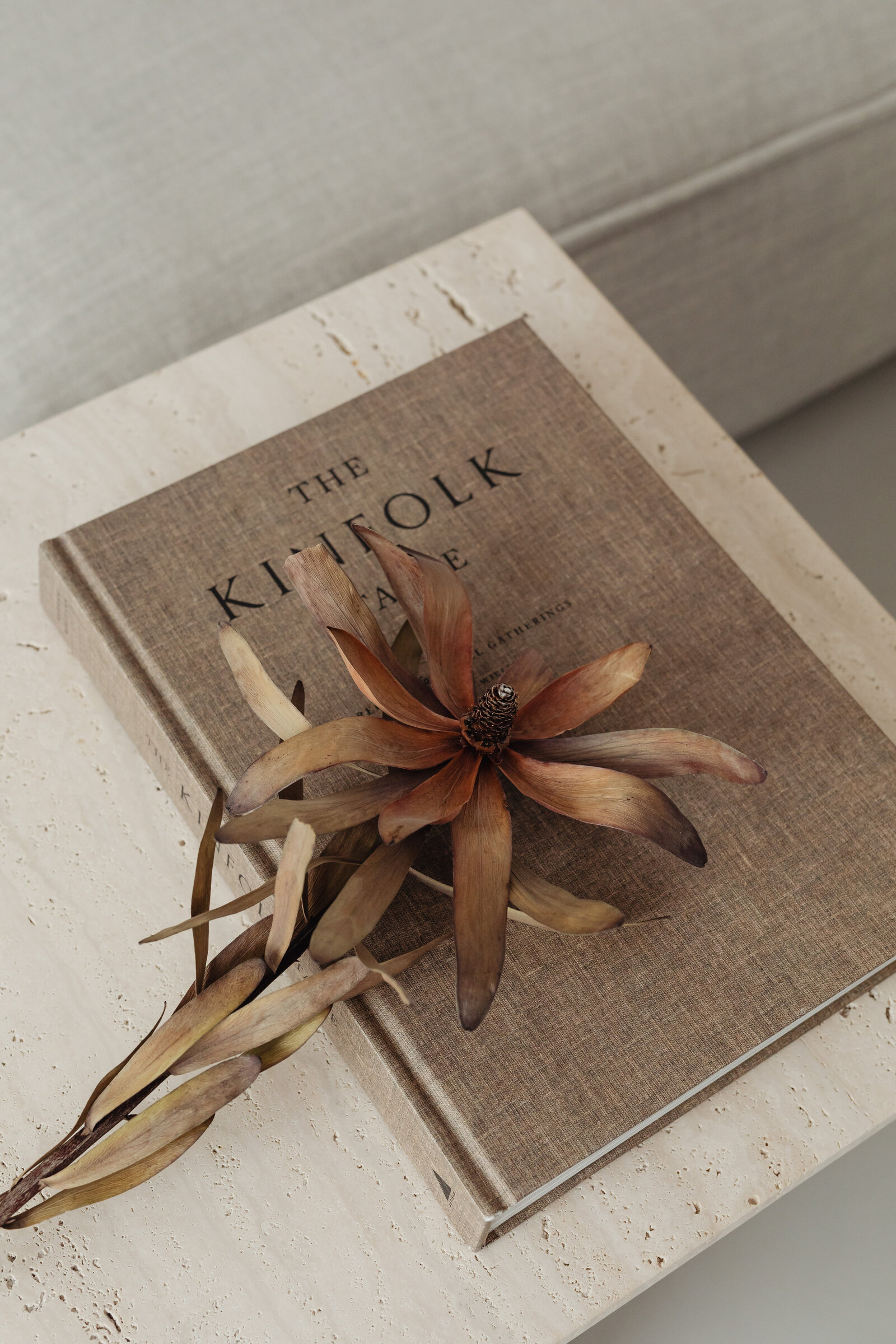 kaboompics_The book lies on a travertine table - Kinfolk - dried flower