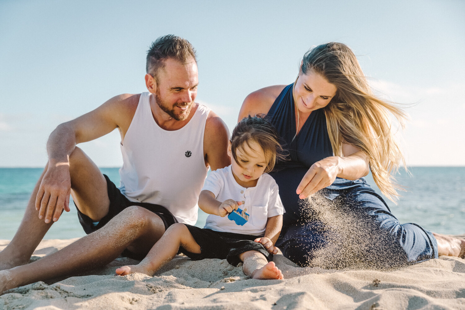 family playing in sand