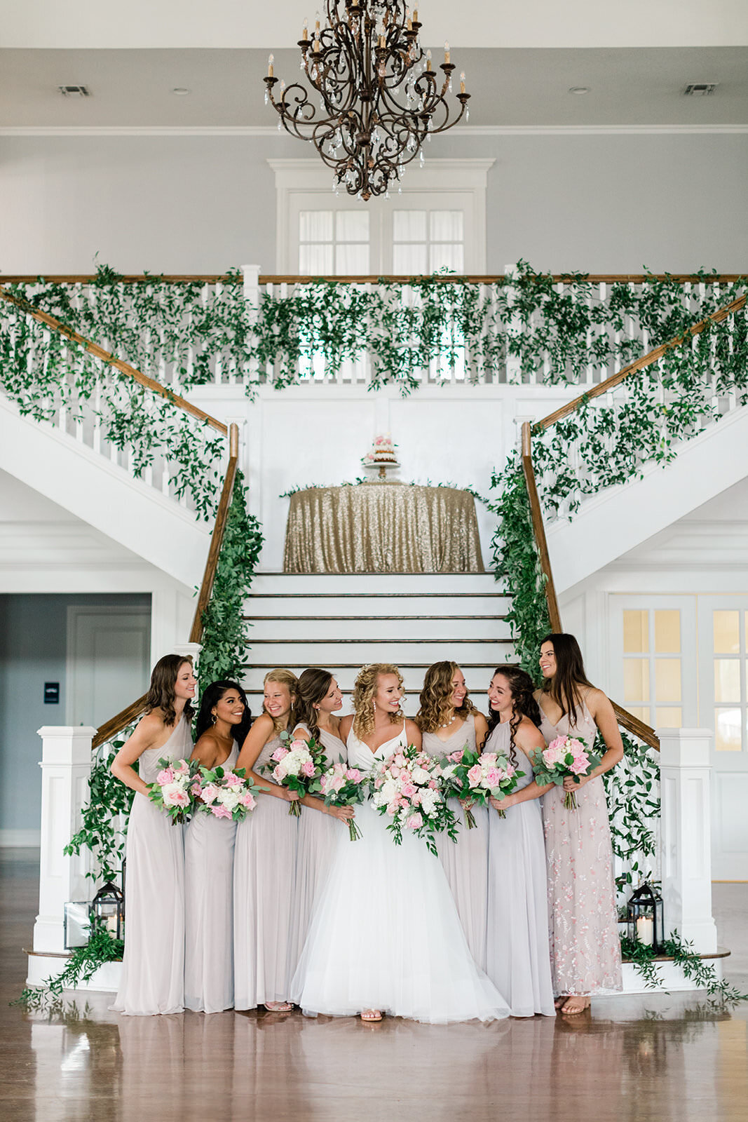 A bridal party smiles inside the Kendall Point ballroom.