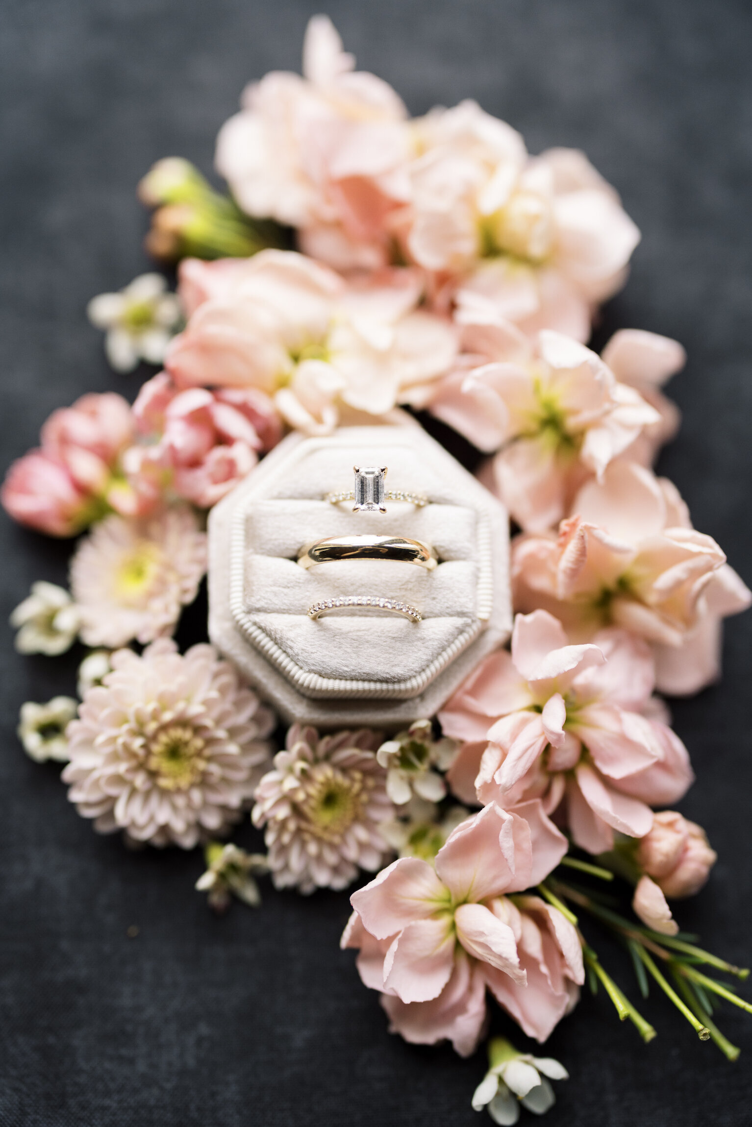 Close-up of an engagement ring surrounded by pink flowers, captured on film by Morgan Alysse, Louisiana film photographer.