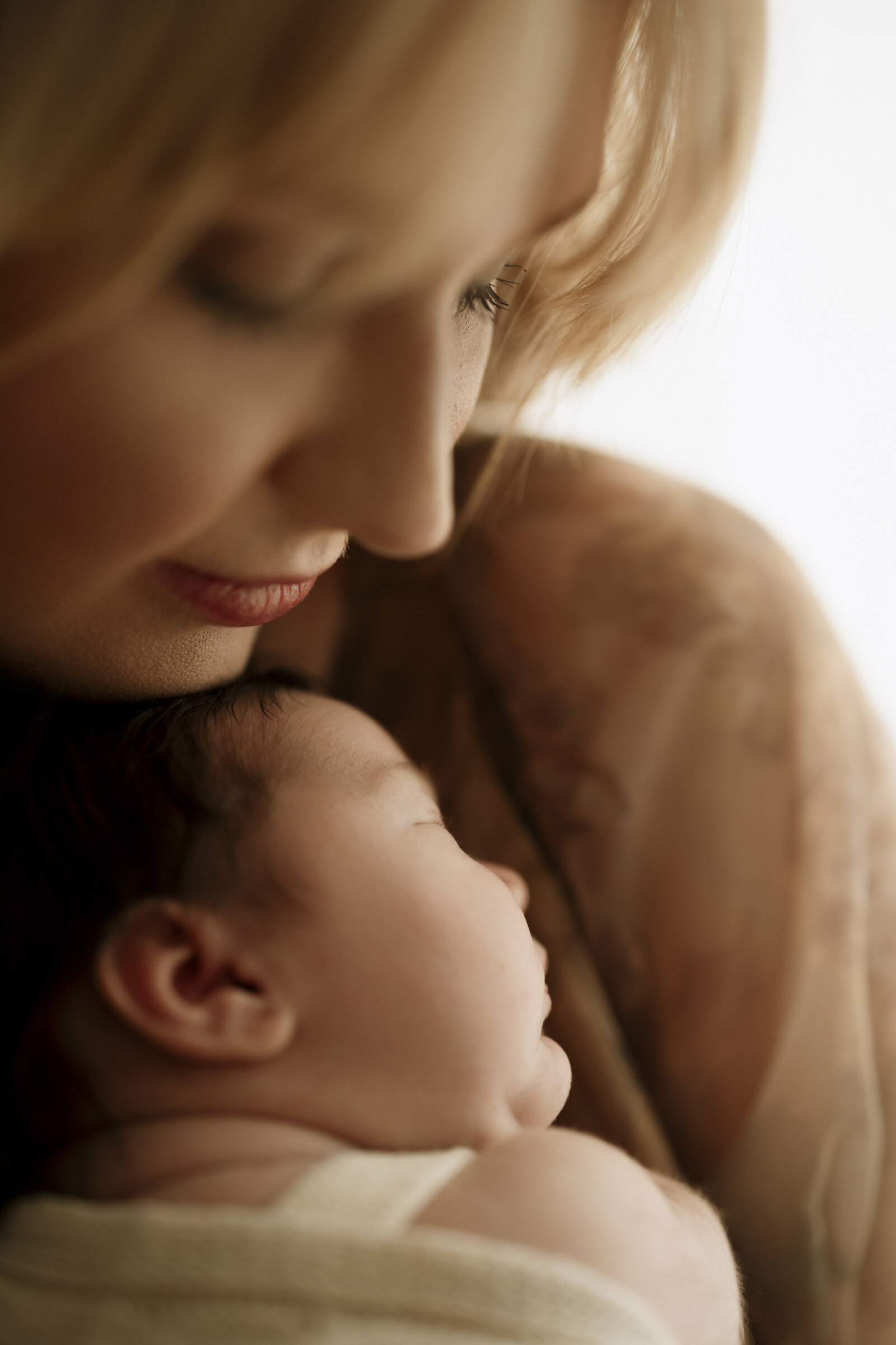 Natural newborn family portraits in a Perth studio – soft, warm, and organic images capturing the love of a growing family.