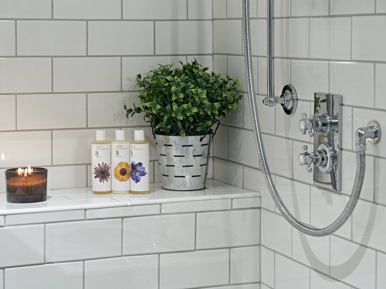 greenery with white tile in bathroom shower