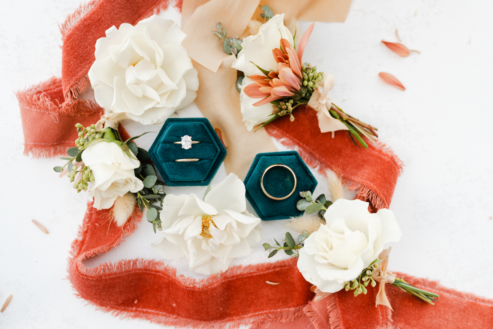 Closeup details of rings and flowers with ribbon