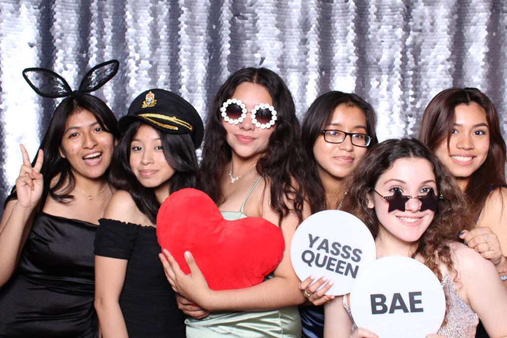 group of young women smiling in an open booth photo booth rental in philadelphia